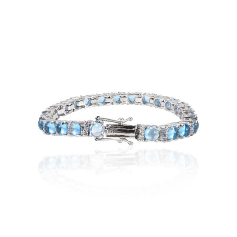 Beautifully handcrafted Blue Topaz and Diamond Tennis Bracelet, designed with love, including handpicked luxury gemstones for each designer piece. Grab the spotlight with this exquisitely crafted piece. Inlaid with natural blue topaz gemstones, this