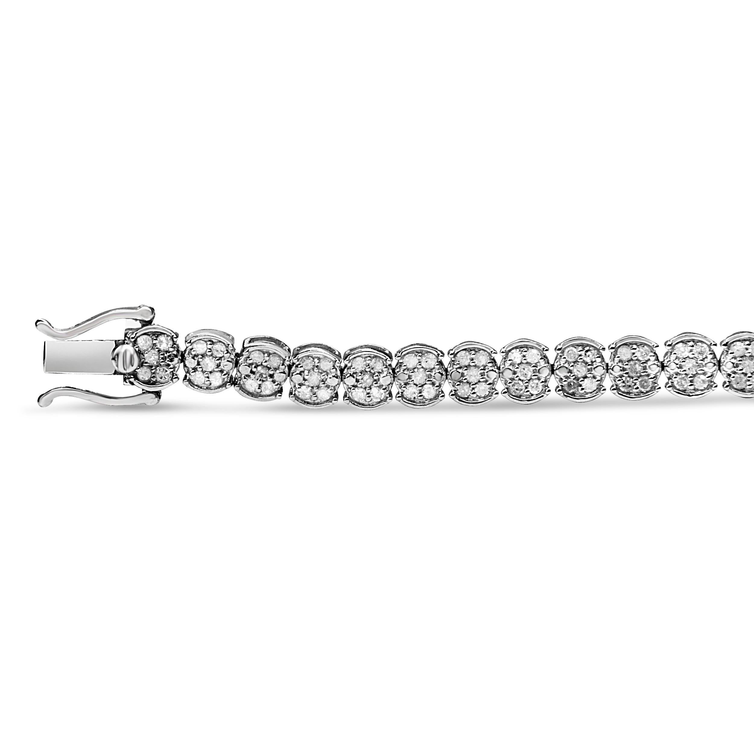 A sparkling enchantment of diamonds creates glistening beauty in this cluster link bracelet. This bracelet radiates modern glamour, perfectly prepared with round diamonds in a prong setting, wrapped in fine .925 sterling silver. The bracelet is