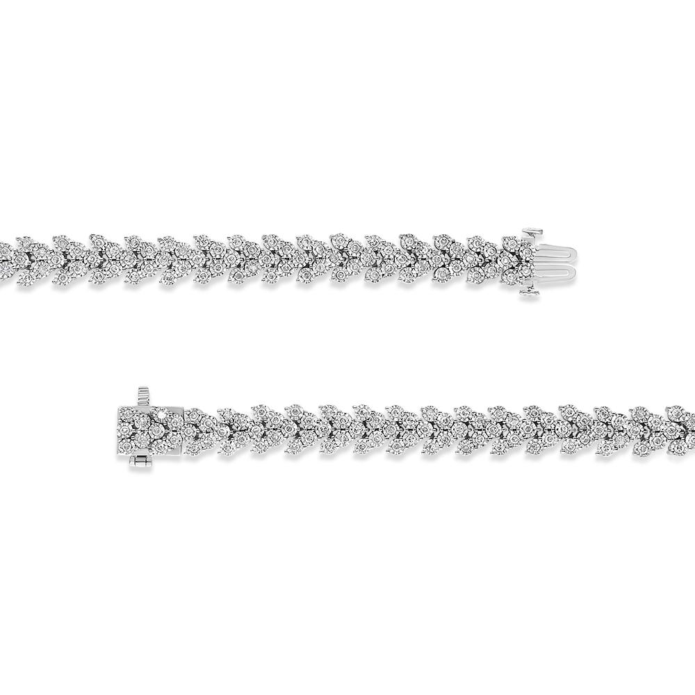 Elegant and whimsical, this vintage-inspired bracelet is a great accessory she'll want to wear often. Crafted in from cool weaves of .925 sterling silver, this laurel wreath inspired style features clusters of shimmering white diamonds. Each diamond