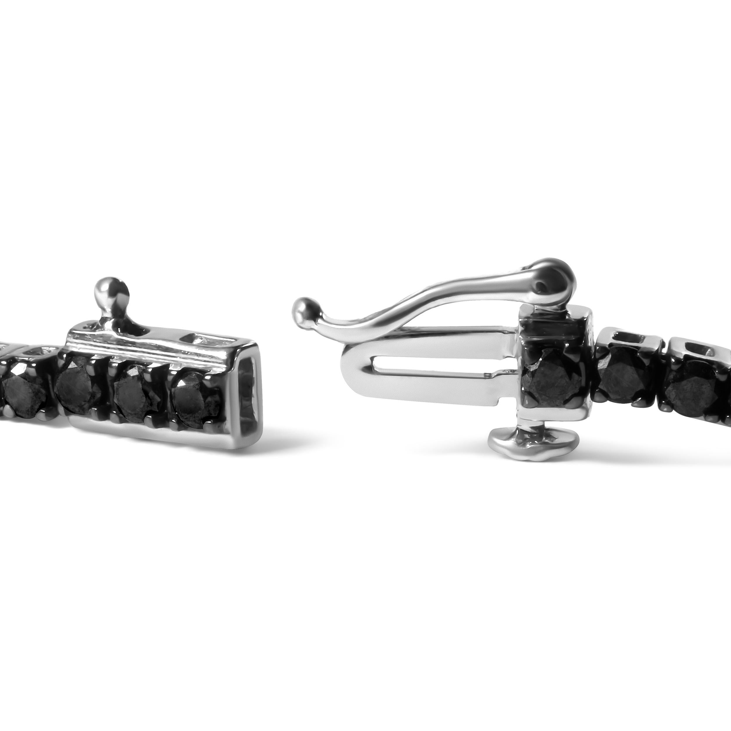 Elegant and timeless, this gorgeous .925 sterling tennis bracelet features 2.0 carat total weight of natural round brilliant cut treated black diamonds with a whopping 78 individual stones in all. The tennis bracelet has hinged links consisting of a