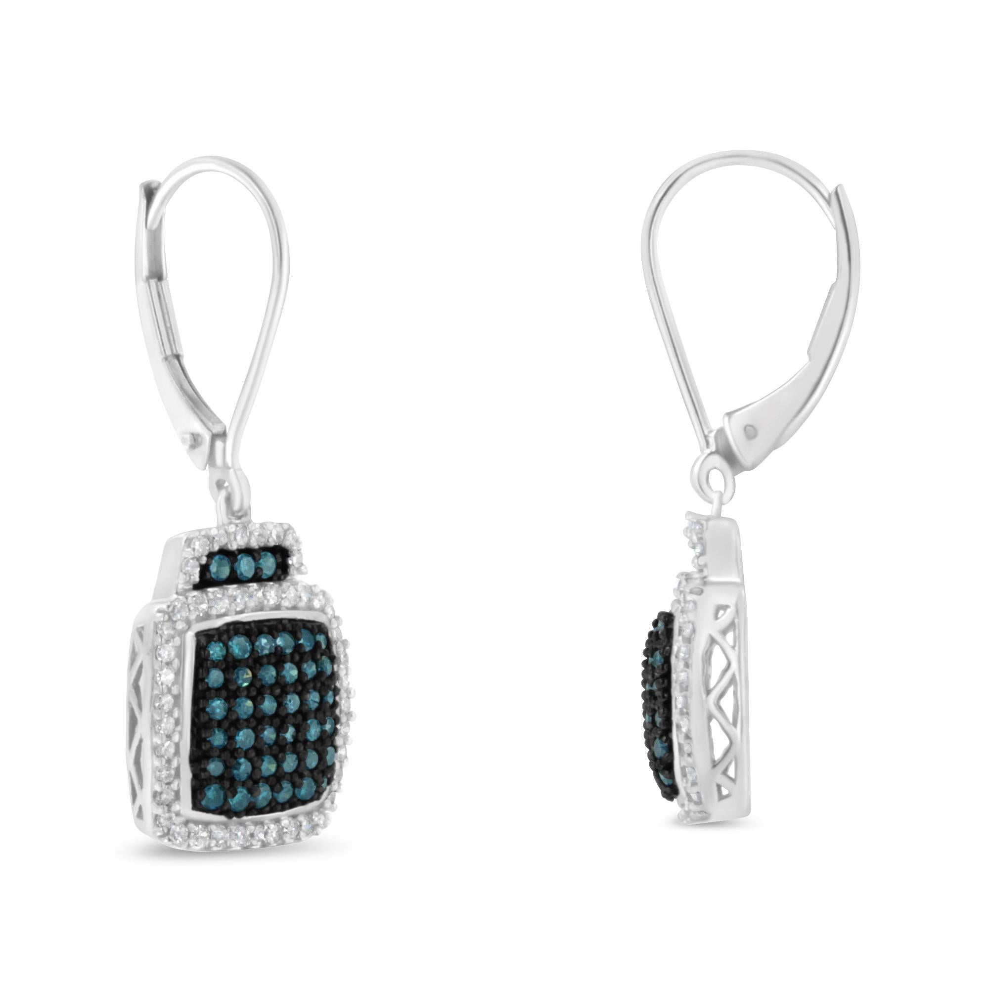 A pair of diamond and sterling silver square dangle earrings. Each earring features a central design of treated blue diamonds surrounded by a halo of white diamonds. The total diamond weight is .75 carats. The are finished with a leverback closure.