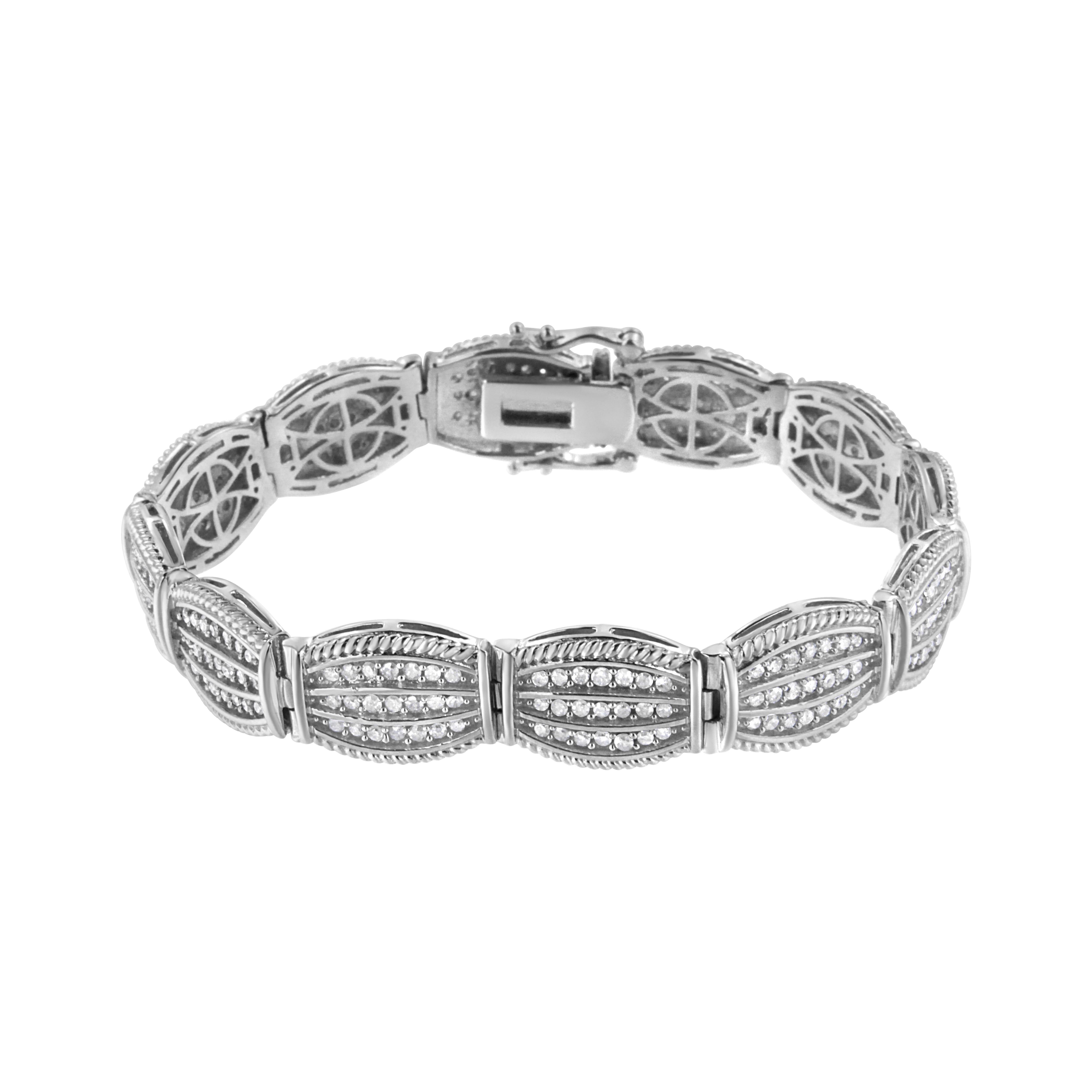 This bracelet is a breathtaking piece. 3ct TDW of round cut diamonds glimmer in this sterling silver art deco link bracelet. Each link has a geometric shape lined with three rows of diamonds. A silver rope ribbon lines the top and bottom of each