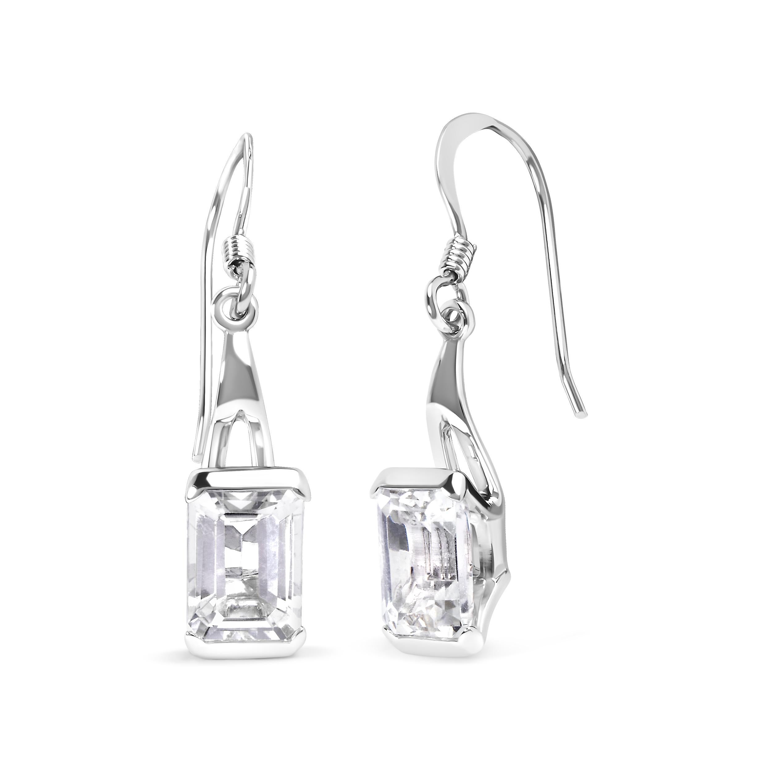 Introducing a dazzling masterpiece that will leave you breathless - a pair of .925 Sterling Silver Emerald Cut White Topaz Solitaire Dangle Earrings. Crafted with love and precision, these earrings boast a remarkable 3.0 cttw of AAA quality white