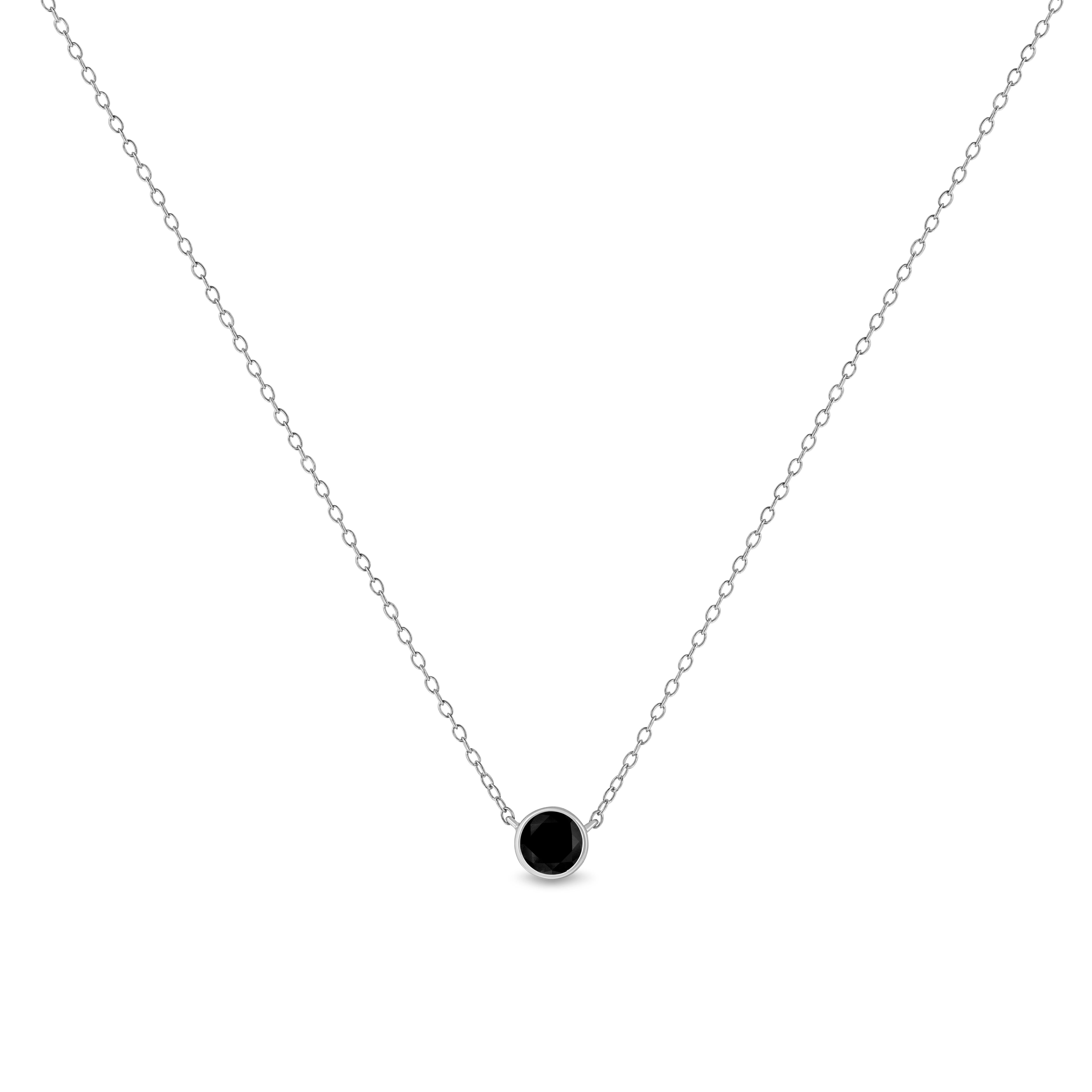 This gorgeous solitaire pendant boasts a stunning single, round-cut treated black diamond in a bezel setting. Designed in the finest .925 sterling silver, this necklace has a total diamond weight of 3 ct. This piece is the perfect accessory to any