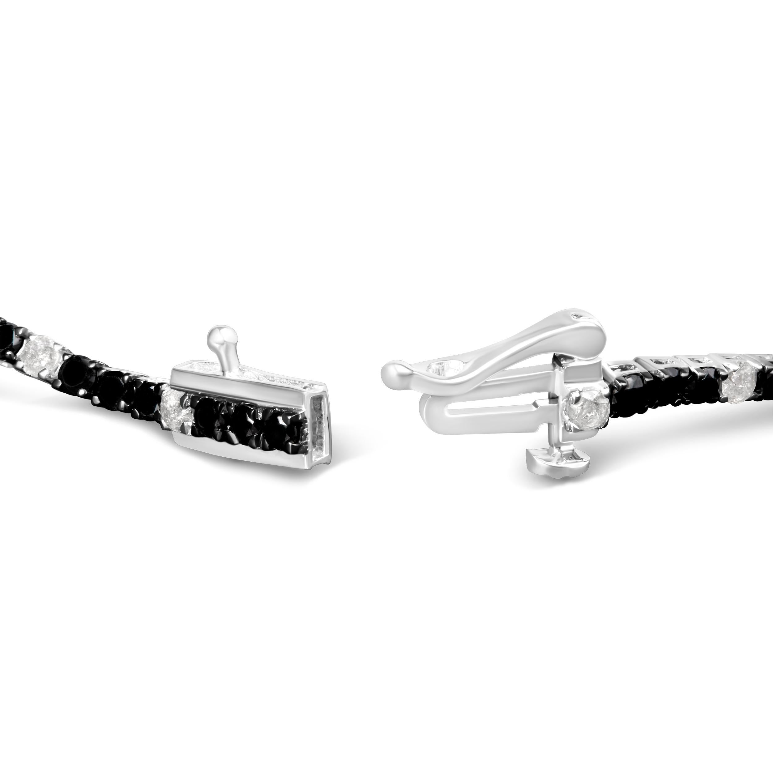 Elevate your style with this striking .925 sterling silver tennis bracelet, featuring a dazzling 3.0 carats of natural diamonds. Alternating between the brilliance of white diamonds and the rich, vivid tones of color-treated black diamonds, this