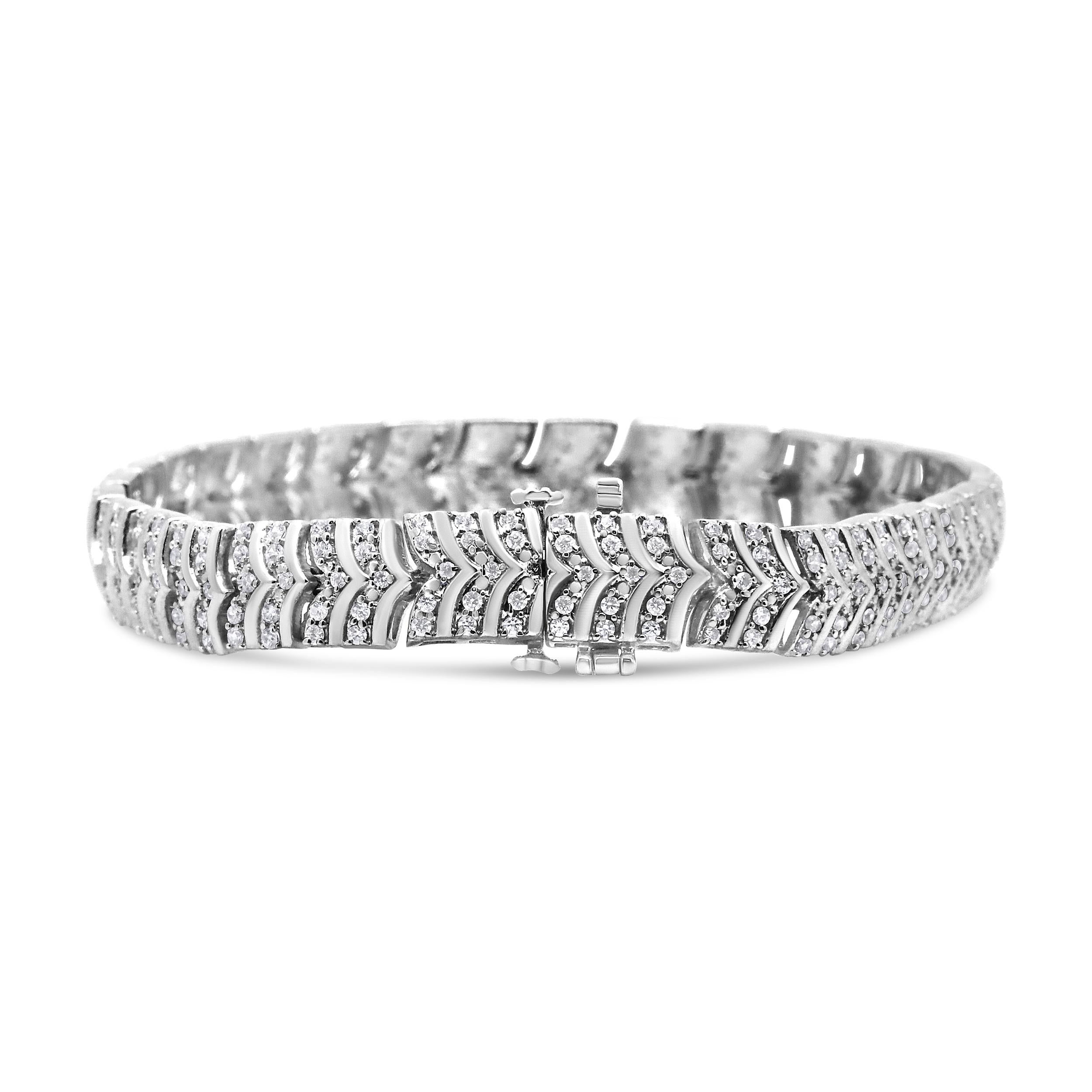 Featuring chevron links crafted of fine .925 sterling silver, this diamond bracelet exudes a timeless modernity that makes it do delectably delicious to wear. Rows of round, pave-set diamonds are featured between each link in a contoured path. The