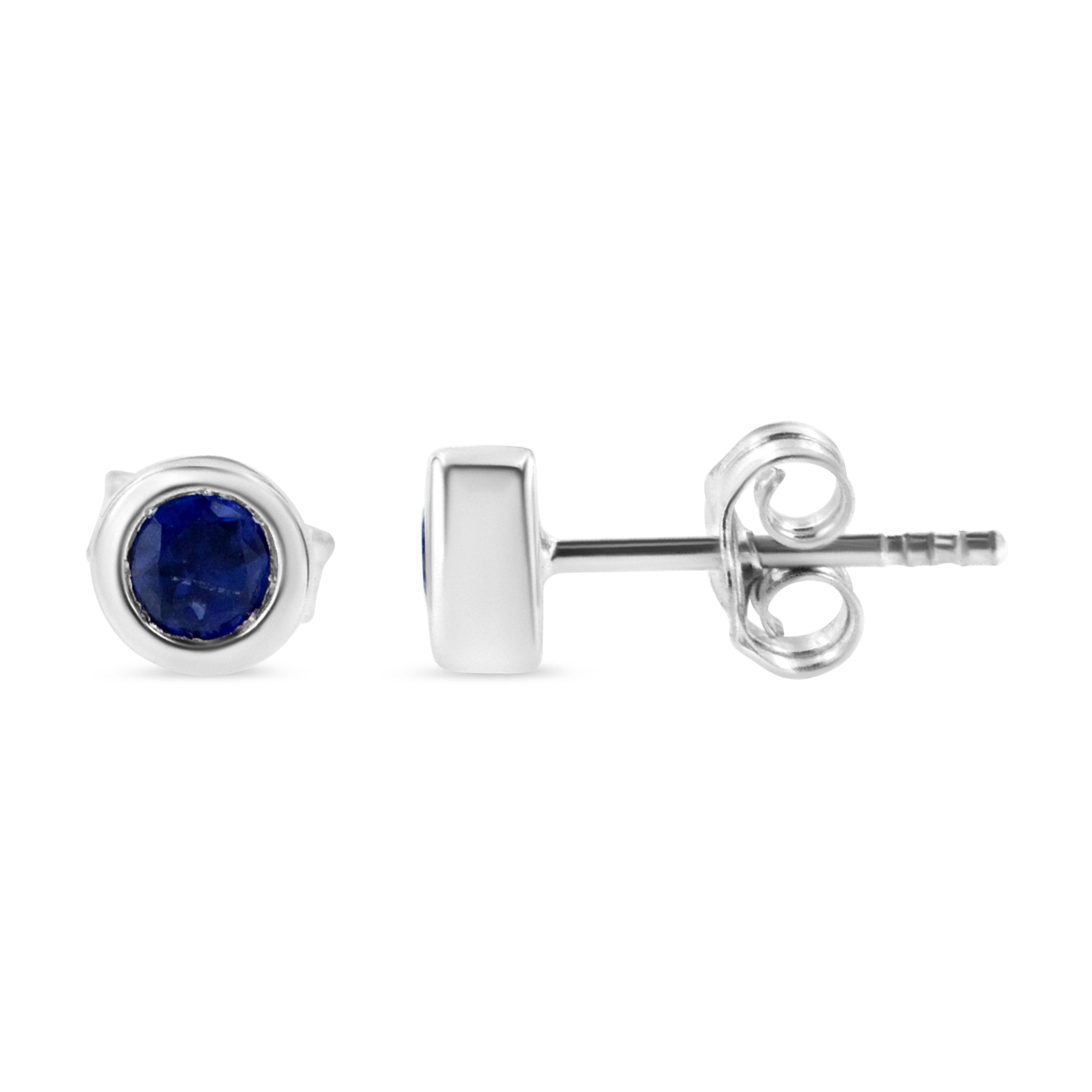 Striking and timeless, these stunning .925 sterling silver solitaire stud earrings feature bold sapphire gemstones in a bezel setting. The gemstones are 3.5mm and treated blue in color. The notched posts and friction backs keep these pierced
