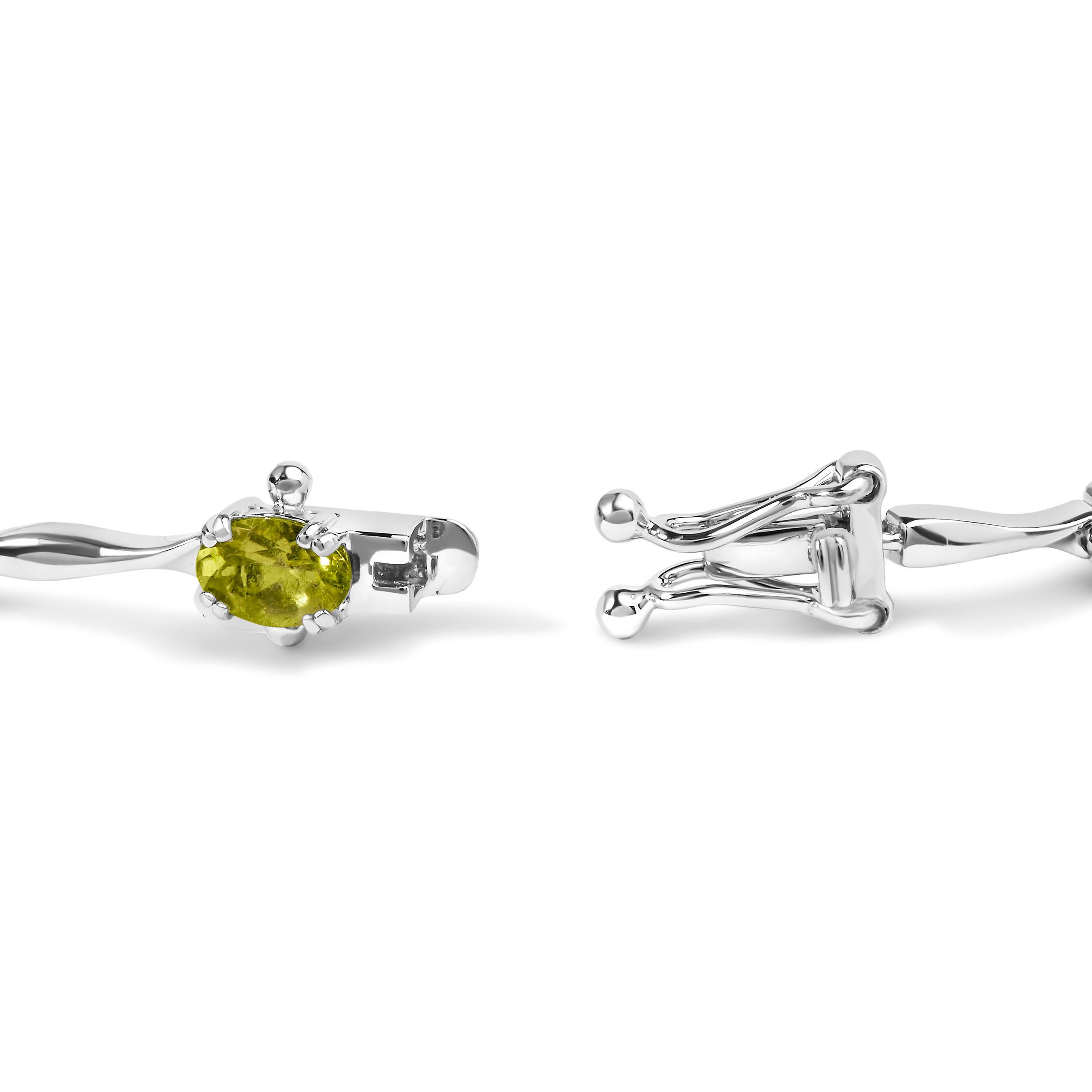 Indulge in the enchanting allure of this exquisite Green Peridot Link Bracelet. Crafted with utmost precision from .925 Sterling Silver, this captivating piece is designed to elevate your style to new heights. The oval-shaped, lab-created Peridot