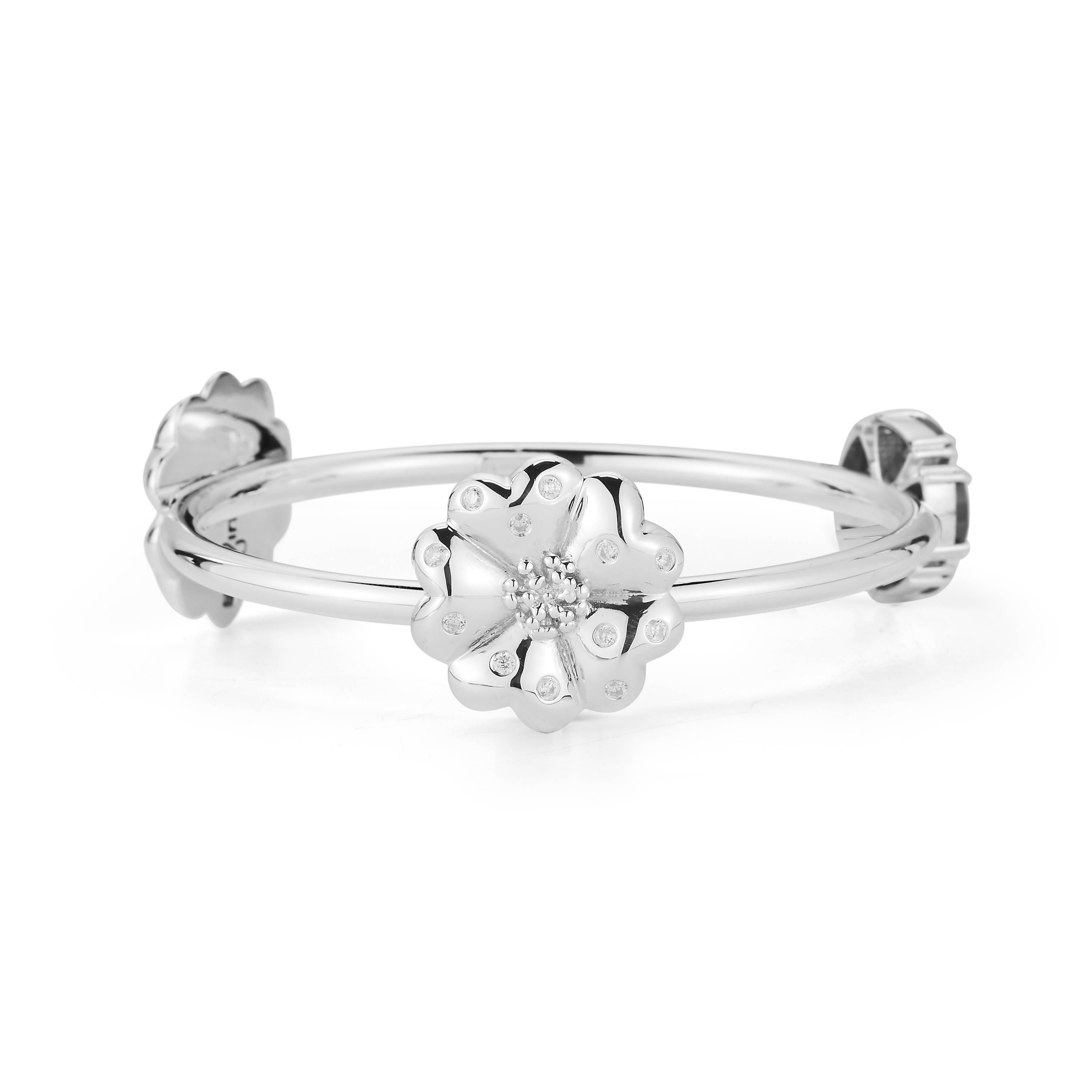 Designed in NYC

.925 Sterling Silver 5 x 7 mm White Sapphire Mixed Blossom Stone Bangle. No matter the season, allow natural beauty to surround you wherever you go. Mixed blossom stone bangle: 

Sterling silver 
High-polish finish
Medium-weight 
3D