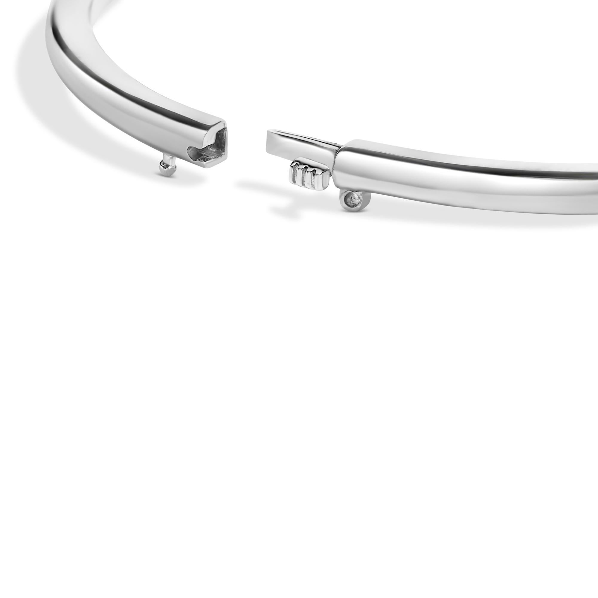 Envelop your wrist in the mesmerizing allure of this rhodium-plated .925 sterling silver bangle, designed expertly to grace a 7-inch wrist with timeless elegance. At its heart lies a 7x7mm lab-created red ruby, its vibrant hue enhanced through