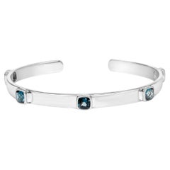 .925 Sterling Silver and Bezel Set Checkerboard Cushion Cut Blue Topaz Bangle