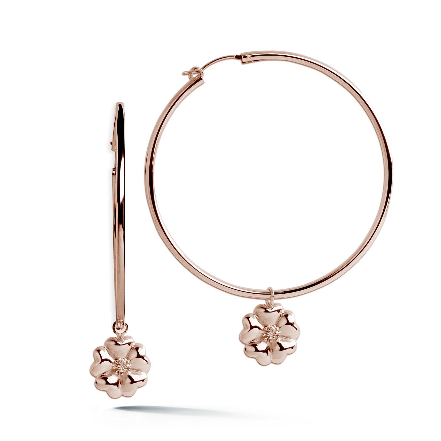 Designed in NYC

.925 Sterling Silver Blossom Dangle Hoops. No matter the season, allow natural beauty to surround you wherever you go. Blossom dangle hoops: 

	Sterling silver 
	High-polish finish
	Light-weight 
	Light weight large high-polish