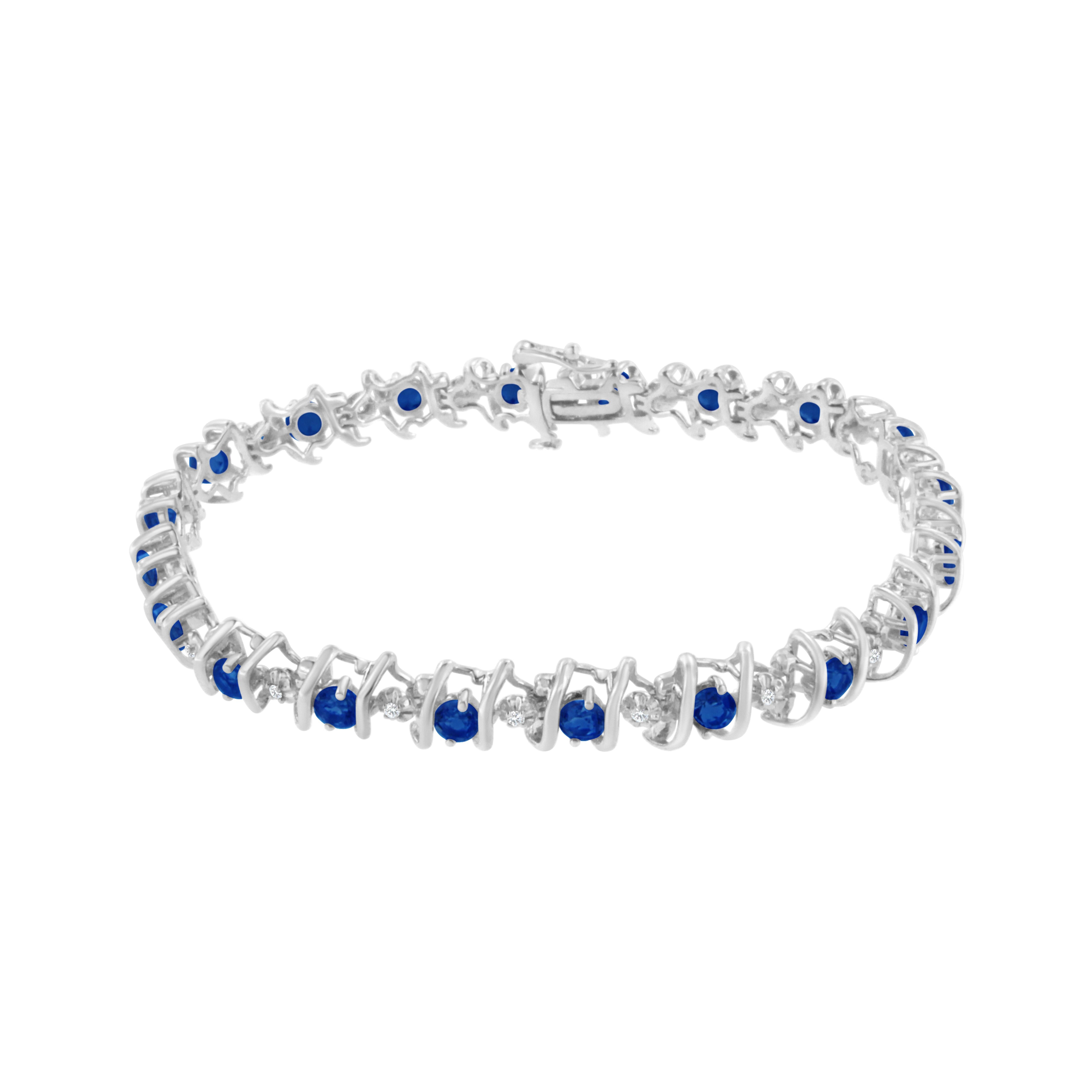 Blue sapphires and sparkling white diamonds are set in a S-link tennis bracelet crafted in cool sterling silver. The bracelet features 20 sparkling diamonds, which have a total weight of .15 carats. The 20 lab-created sapphires add brilliant color