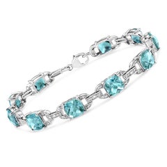 .925 Sterling Silver Blue Topaz and 1/20 Carat Diamond Fashion Tennis Bracelet
