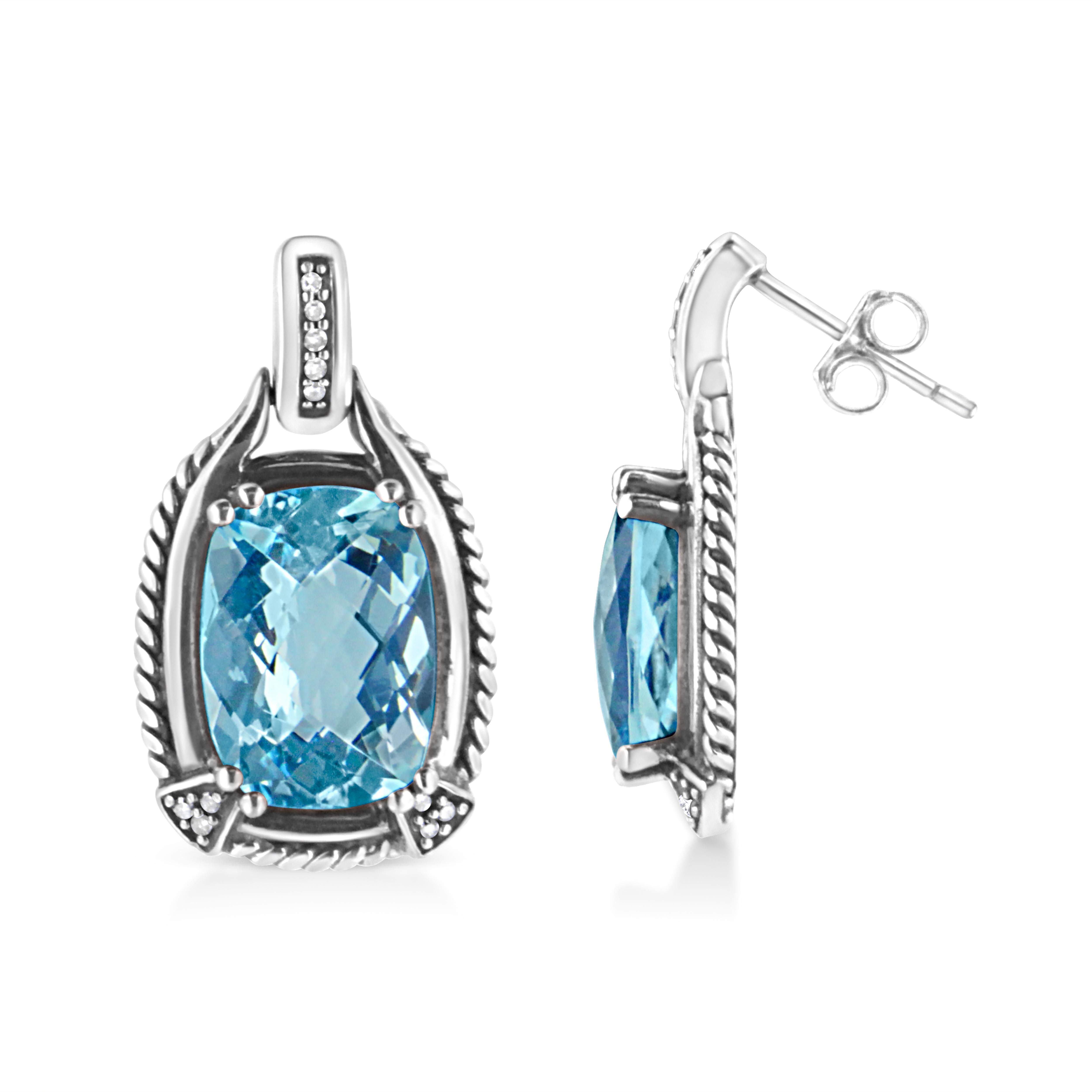 These mesmeric blue topaz and diamond earrings is a sweet illumination for her ears. Styled in luminous sterling silver these ravishing earrings is jeweled with a large cushion cut blue topaz. Accenting its vibrant, 22 sparkling single cut diamonds