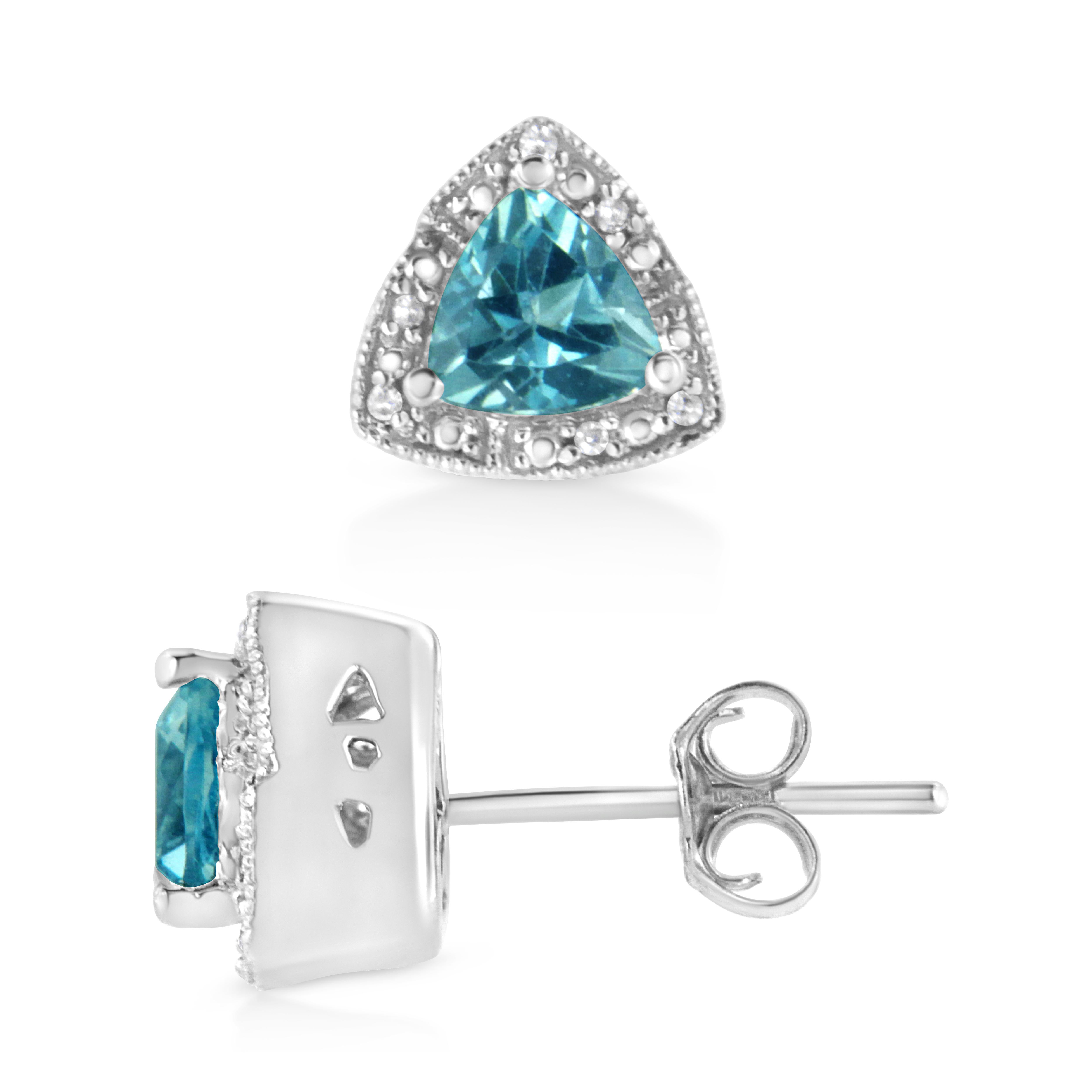 Give these enchanting pair of blue topaz and diamond earrings to the one you desire. These earrings showcases a centrally staged gorgeous trillion cut prong set blue topaz dramatically haloed by 12 single cut diamonds, beautifully prong set and