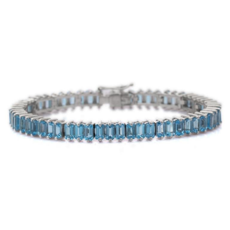 Beautifully handcrafted Blue Topaz Tennis Bracelet, designed with love, including handpicked luxury gemstones for each designer piece. Grab the spotlight with this exquisitely crafted piece. Inlaid with natural blue topaz gemstones, this bracelet is