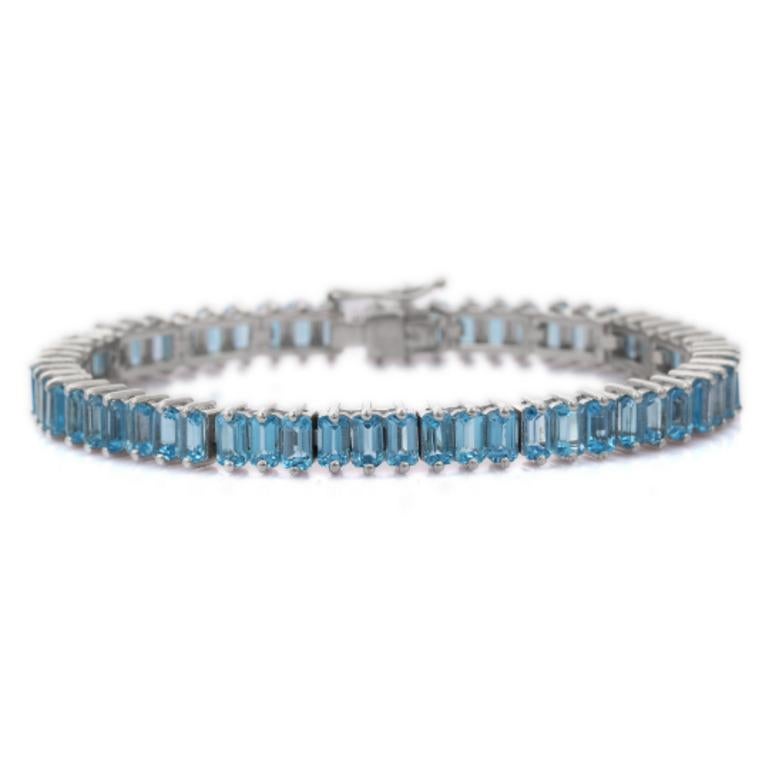 Blue Topaz Tennis Bracelet for Wedding in sterling silver showcases endlessly sparkling natural blue topaz, It measures 7.5 inches long in length. 
Blue Topaz stimulate concentration and reduces stress. 
Designed with perfect octagon cut blue topaz