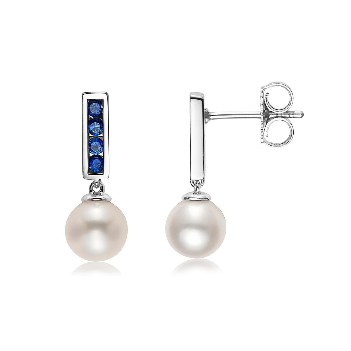 Gorgeous Akoya Pearls measuring 7mm dangle from channel-set genuine blue sapphires with .925 Sterling Silver. This is a modern classic and sure to add a pop of color to your look. Great for everyday wear, these earrings are as versatile as they are
