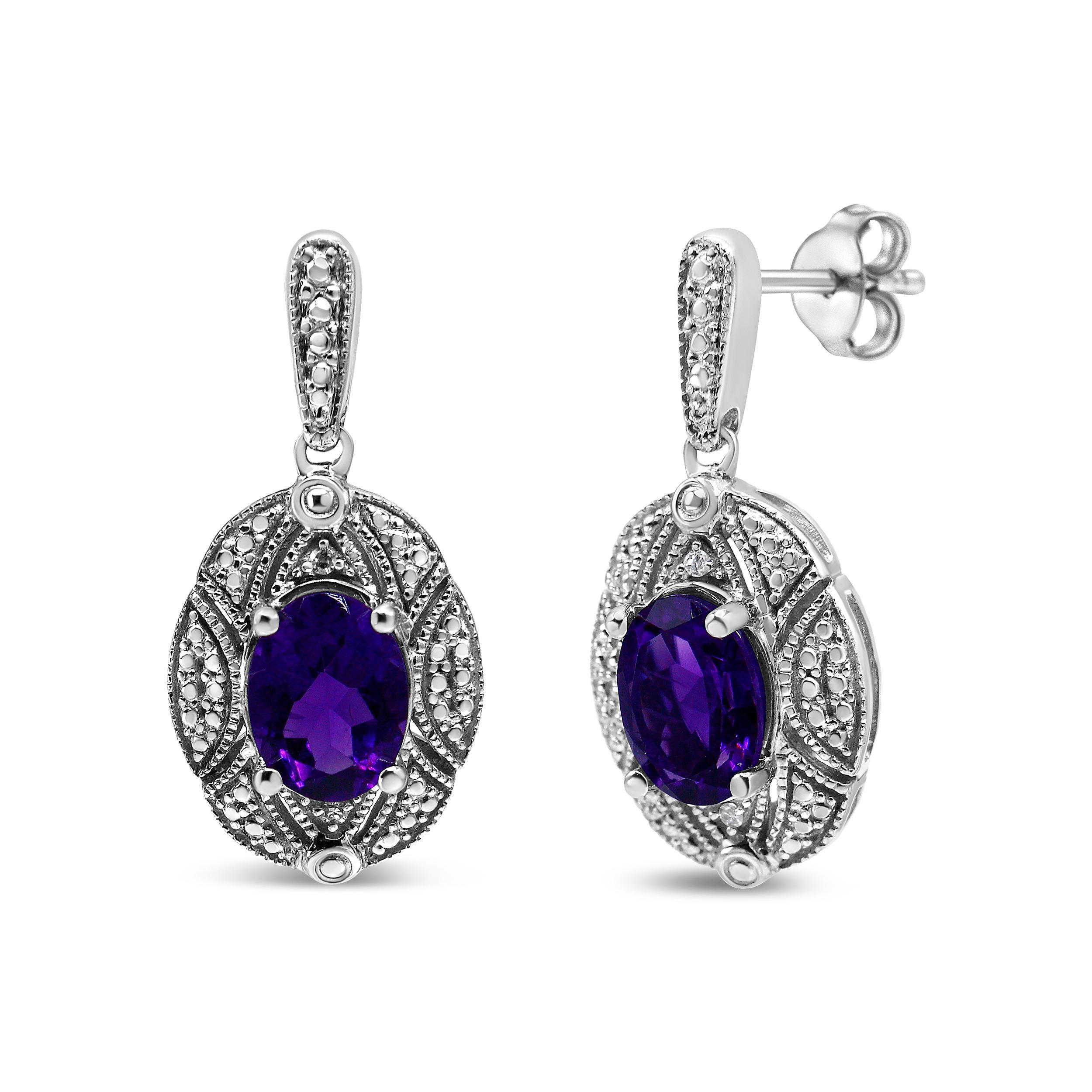 These elegant diamond accent and gemstone stud earrings boast a glorious sense of style! Set in .925 sterling silver, a 8*6mm oval-cut amethyst gemstone in purple glows against a halo of intricate milgrain detailing and round-cut white accent