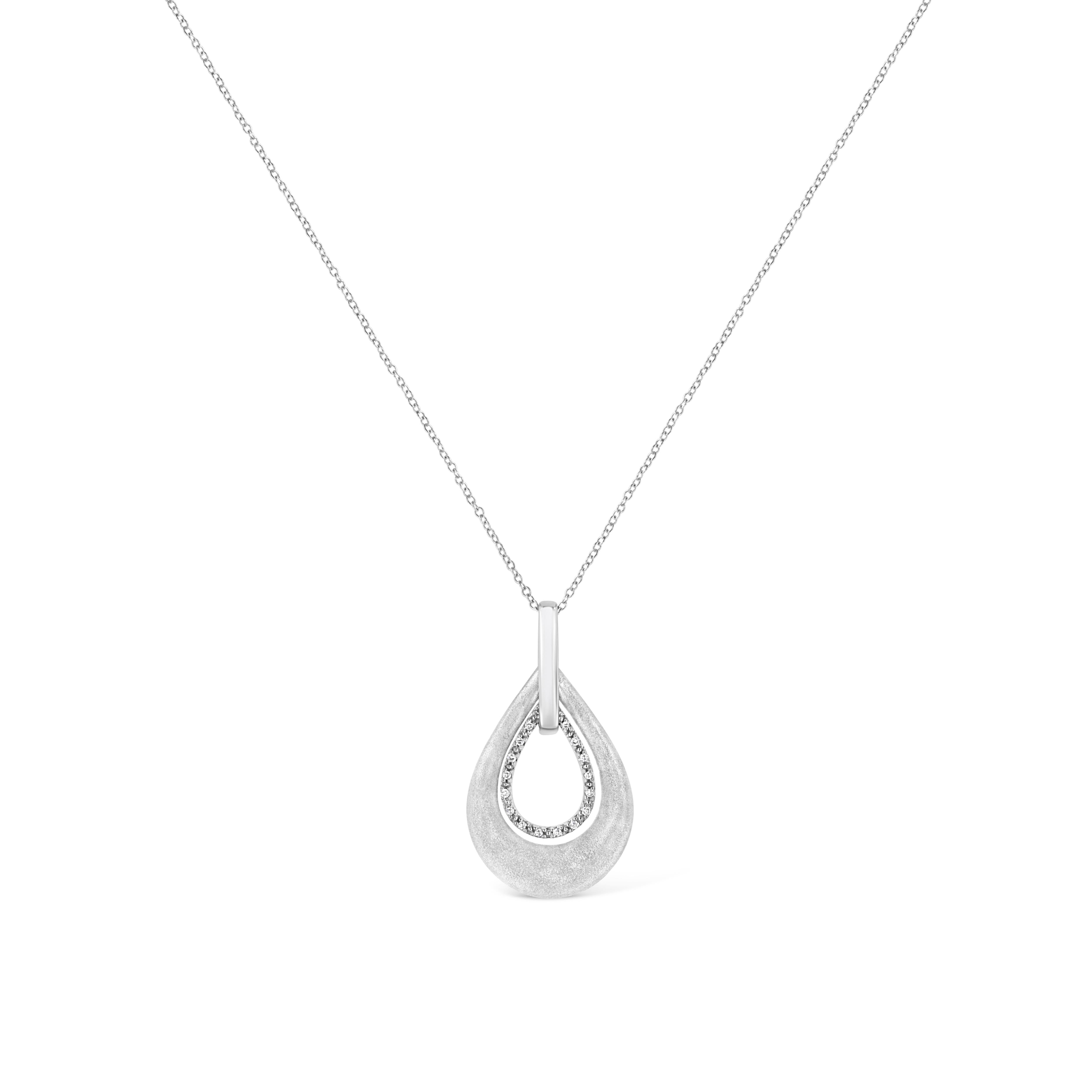 Make her feel glamorous with this radiant diamond fashion pendant. Fashioned in luminous sterling silver this pendant showcasing 18 sparkling prong set round cut diamonds, set on pear motif and dangles from a shimmering cable chain. Total diamond