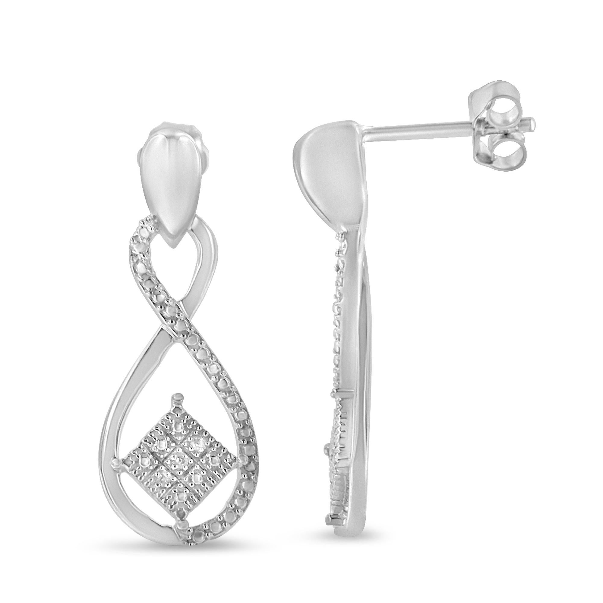 Uniquely designed in the infinity shape, the earrings feature square accents in the center. Composed of alluring sterling silver, the pair of earrings is polished high to shine. They are beautifully adorned with round cut diamonds that are arranged