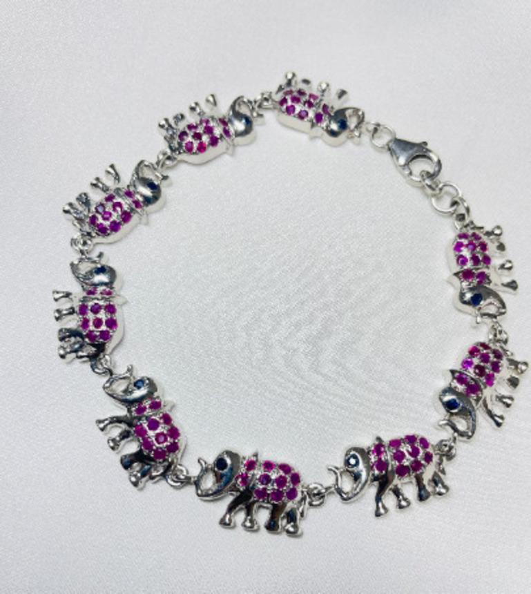 Elephant Charm Bracelet with Ruby and Sapphire for Her in sterling silver showcases endlessly sparkling natural rubu, sapphire, weighing 3.78 carat. It measures 7.25 inches long in length. 
Ruby, Sapphire stimulate concentration and reduces stress.