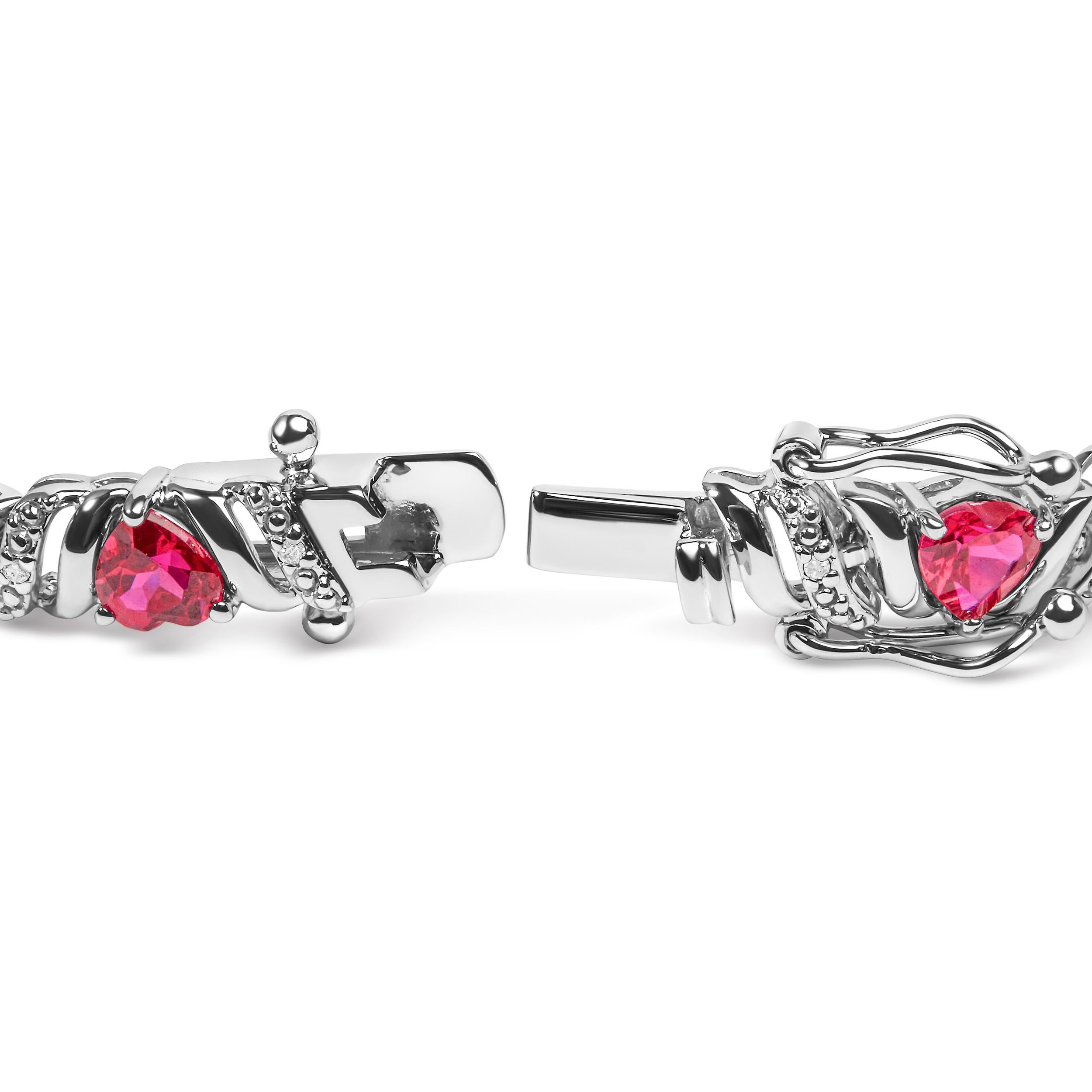 Indulge in the epitome of elegance with this exquisite .925 Sterling Silver Link Bracelet. Crafted with love, the heart-shaped Red Ruby gemstones exude passion and allure, captivating all who gaze upon them. The 17 dazzling Round White Diamond