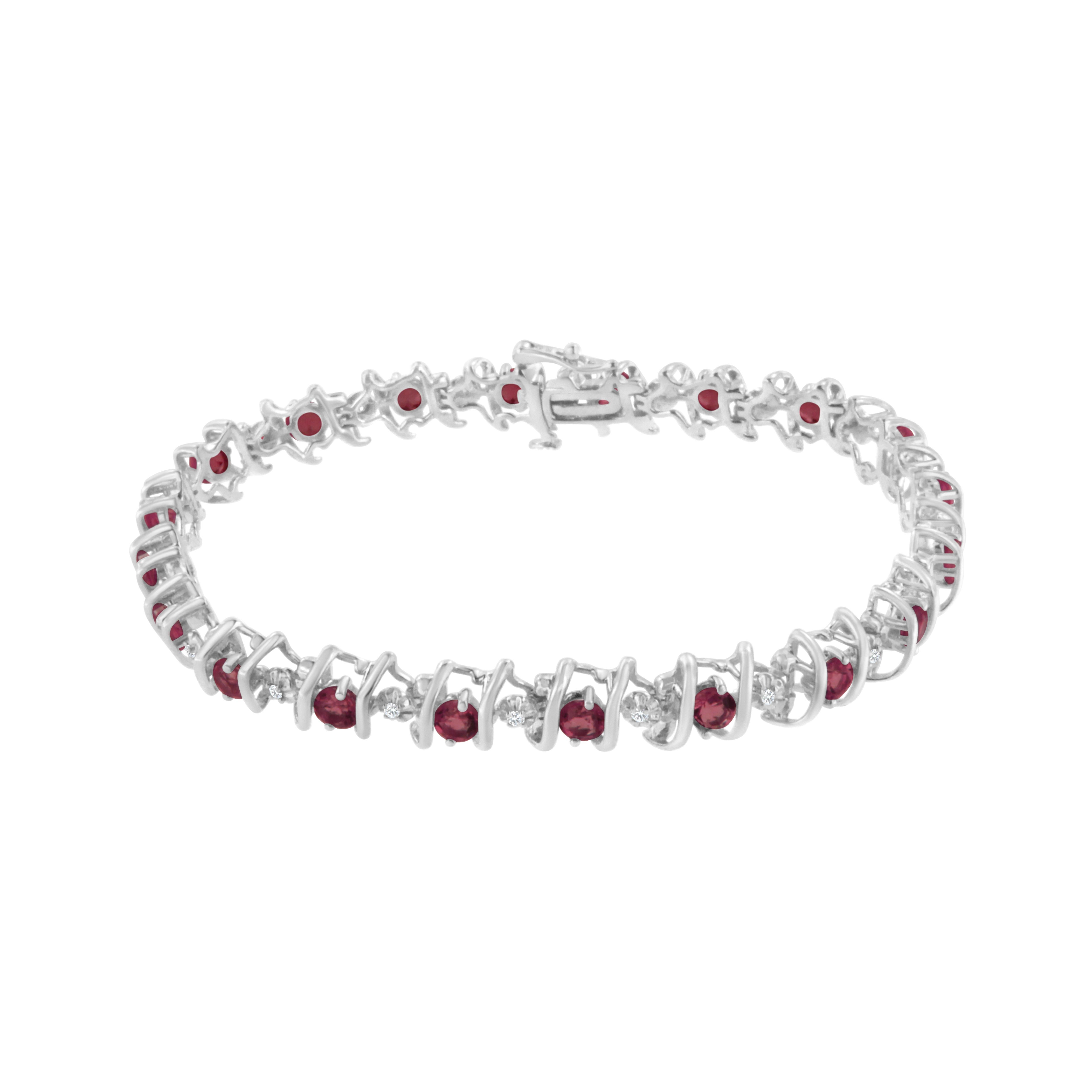 Red rubies and sparkling white diamonds are set in a S-link tennis bracelet crafted in cool sterling silver. The bracelet features 20 sparkling diamonds, which have a total weight of .15 carats. The 20 lab-created rubies add brilliant color to the