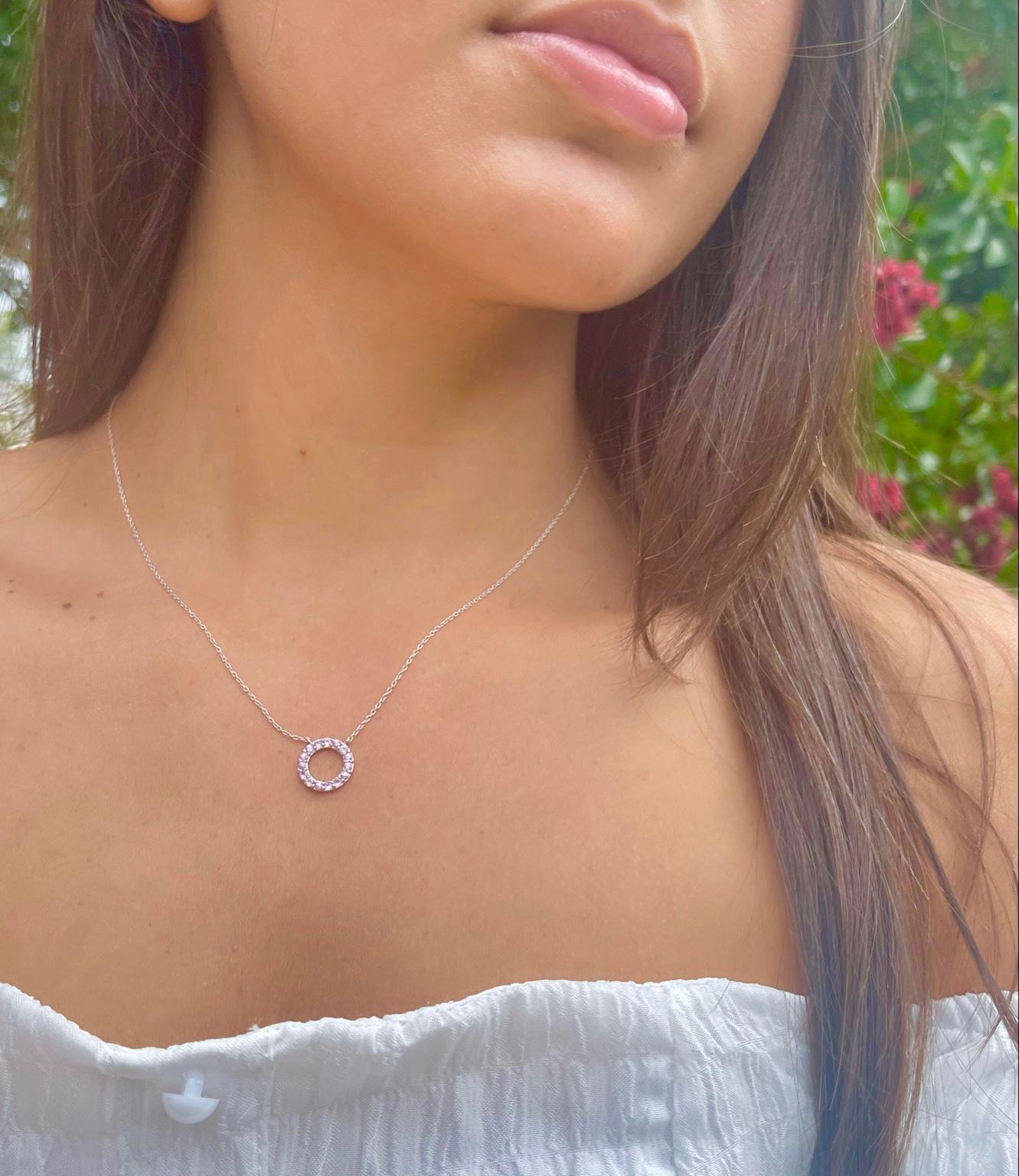 Genuine pink sapphires in a classic circle shape is the perfect necklace to layer or wear on its own. Enjoy this necklace as an everyday piece! Made with .925 Sterling Silver. 1.79 total carats. External diameter of the circle measures 0.5