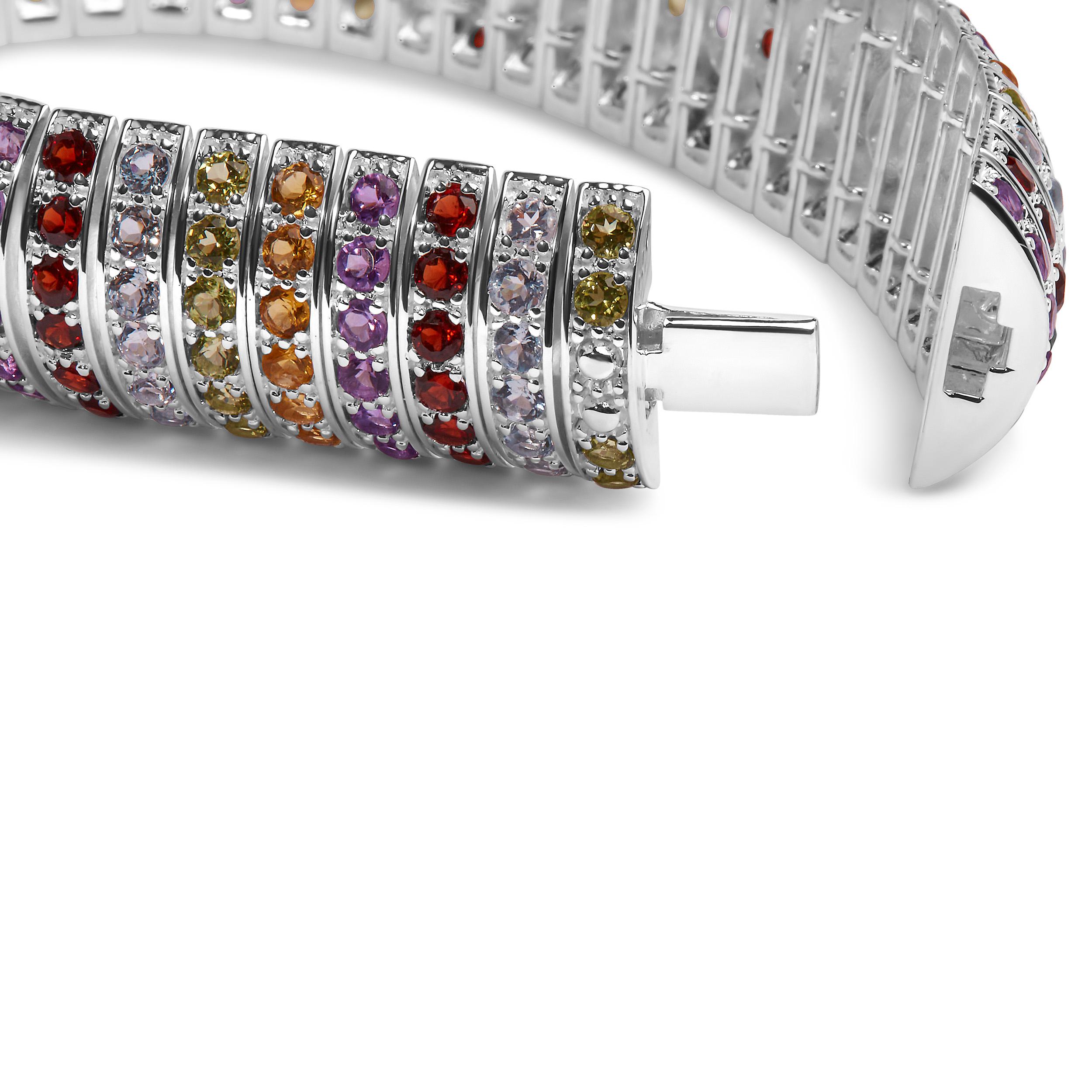 Introducing a mesmerizing masterpiece crafted with passion and finesse. This .925 Sterling Silver Multi Row Rainbow Gemstone Bangle Bracelet is a symbol of elegance and sophistication. Adorned with a plethora of vibrant gemstones including Amethyst,