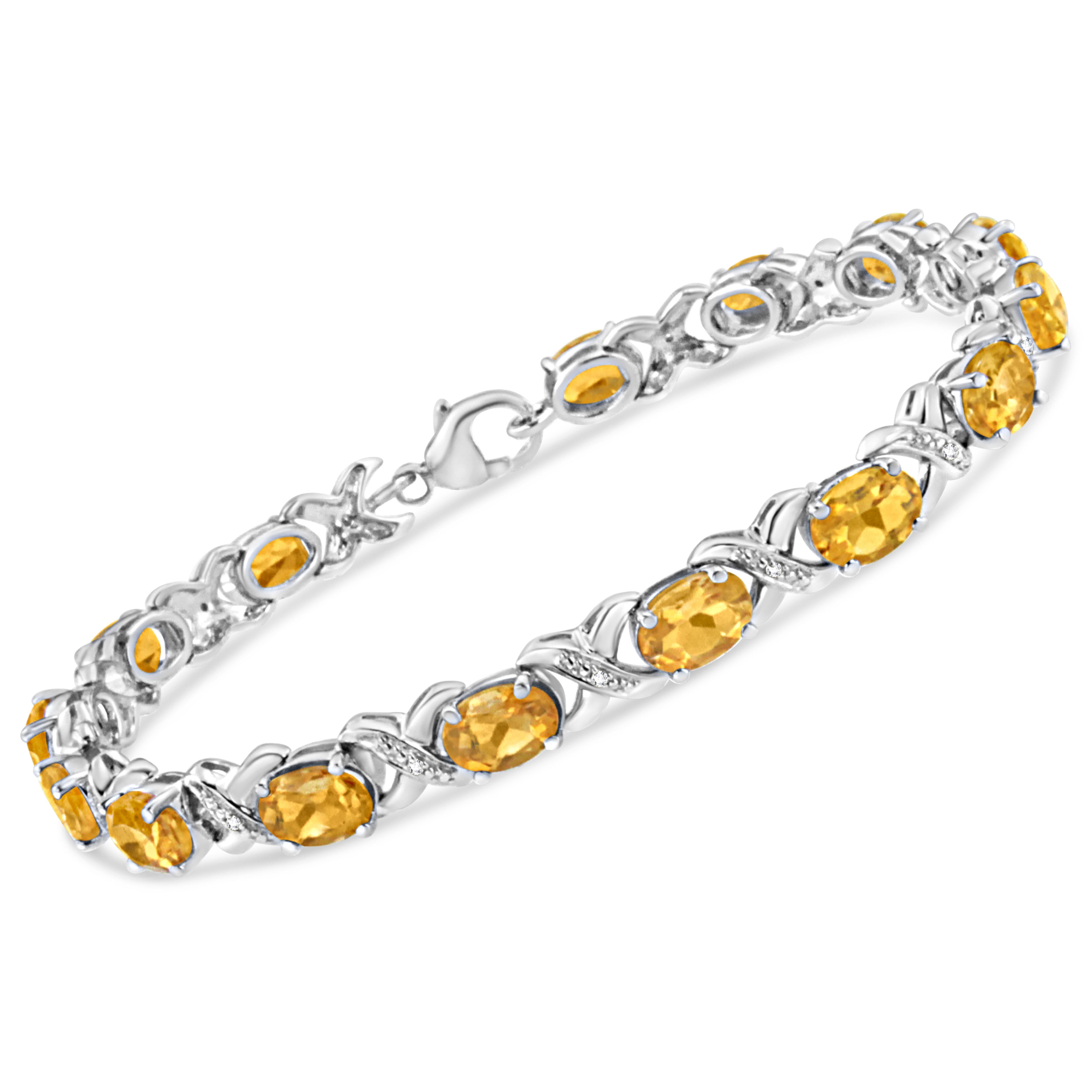Make a style statement with this resplendent citrine and diamond tennis bracelet. Styled in remarkable sterling silver this bracelet is embellished with 15 alluring prong set oval cut citrine accentuated by 15 brilliant round cut diamonds in prong