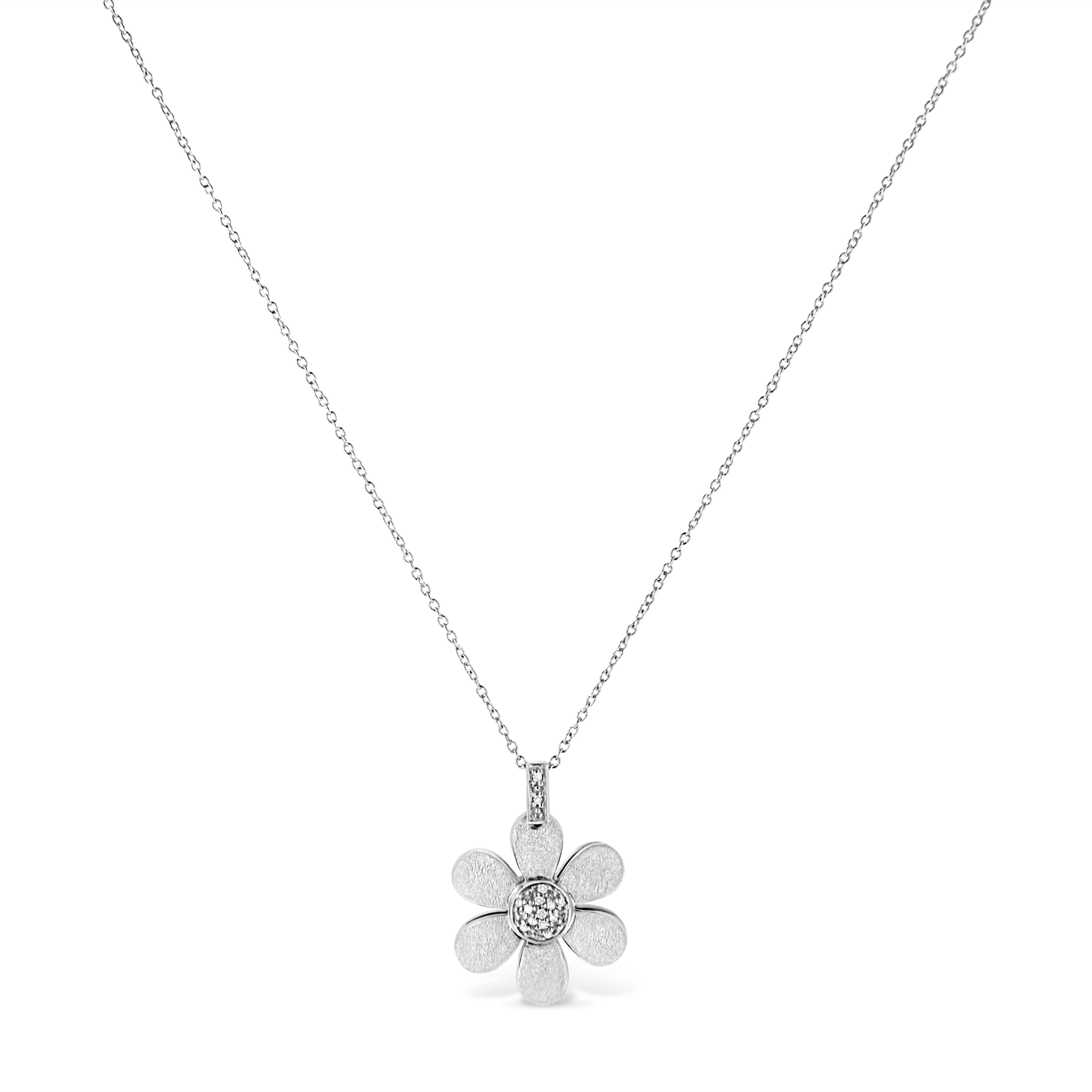 This gorgeous flower pendant expresses your style. Styled in lustrous sterling silver, this floral designed Pendant is embellished with a cluster of 14 dazzling round cut diamonds at the center, elegantly pave set. The pendant hangs from a beautiful