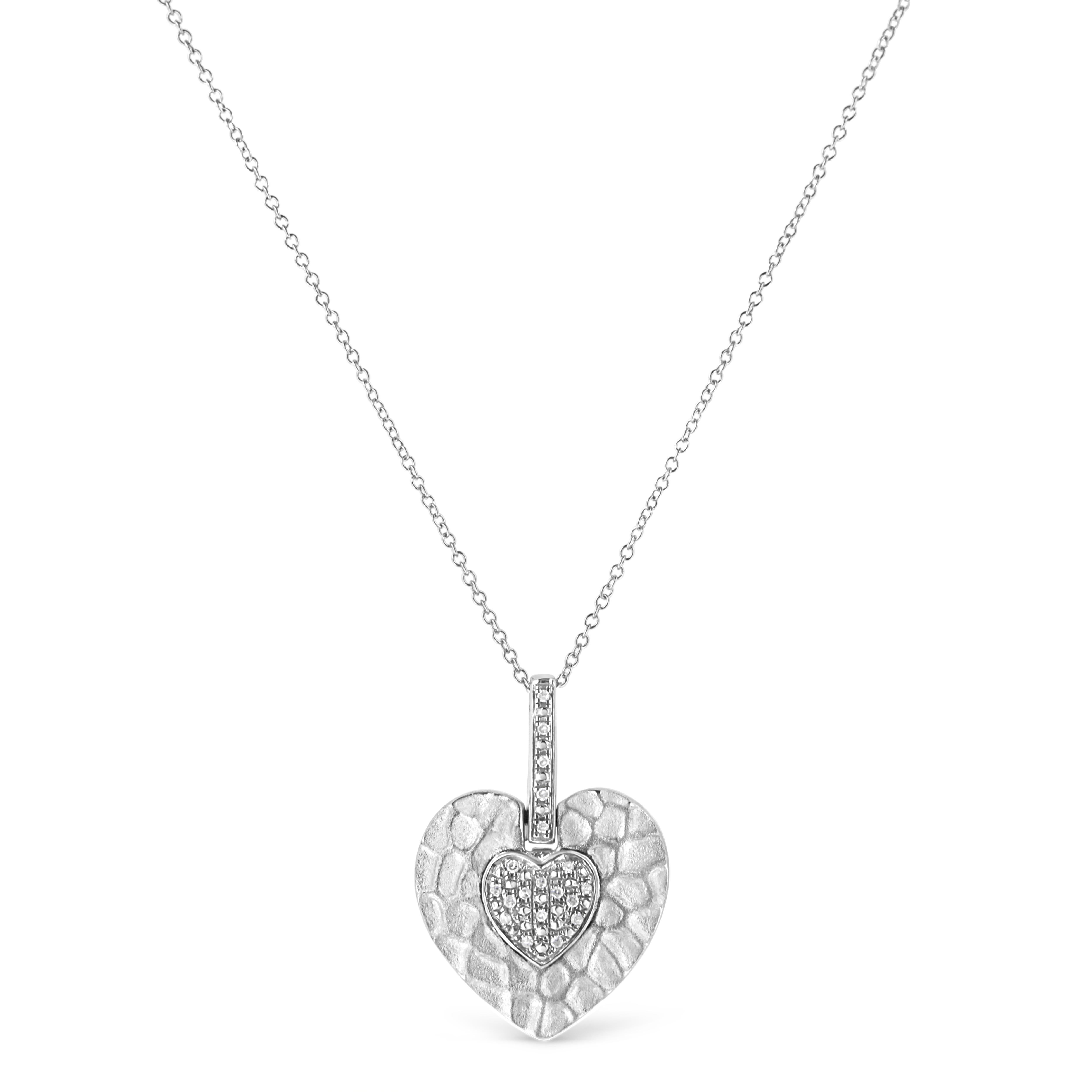 Express the expression of love for her with this stunning Diamond pendant. Styled in 925 sterling silver this pendant showcase 20 pave set single cut diamonds that form a small heart inside of a large pre-designed heart. The pendant hangs from a