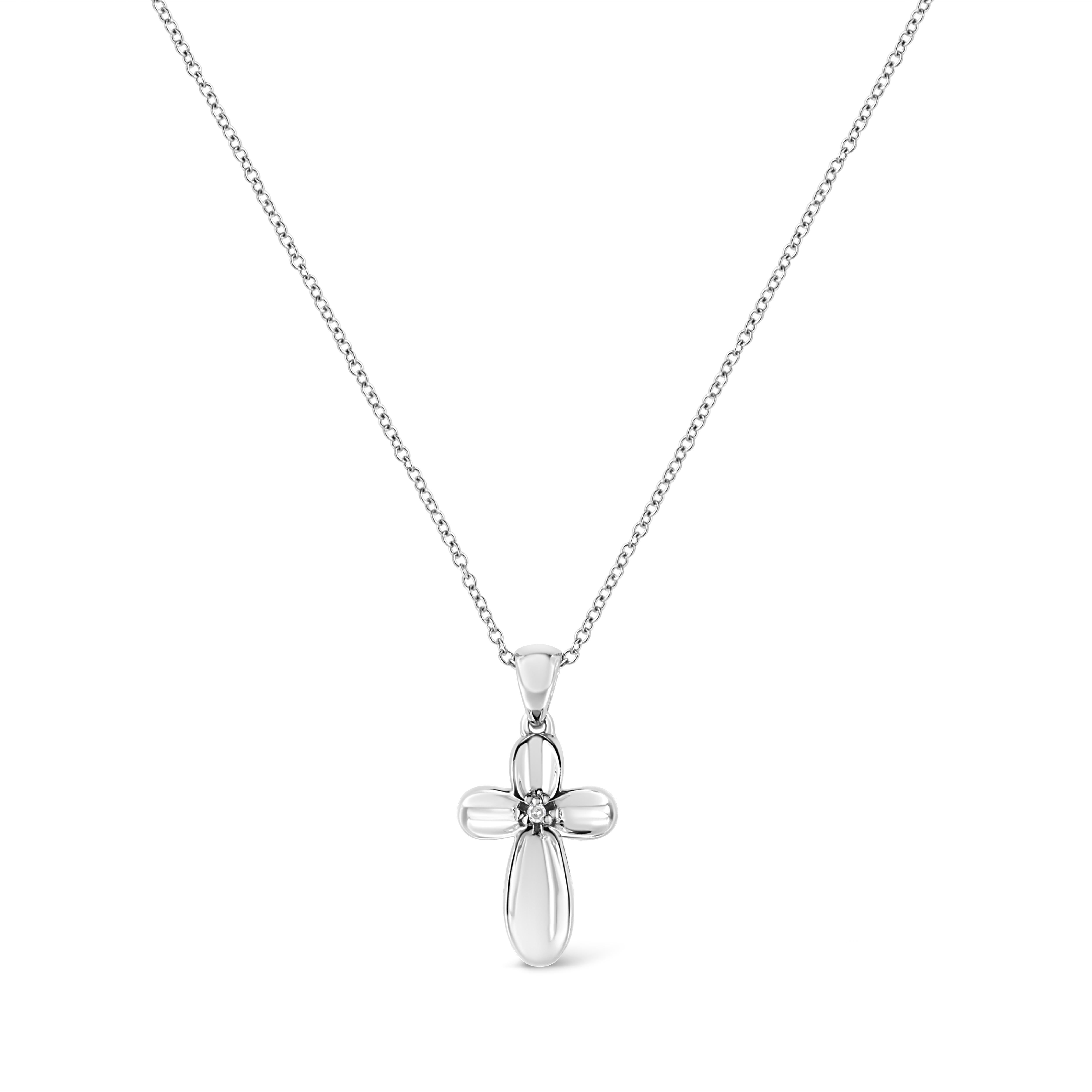 This classic diamond cross pendant is a beautiful symbol of divine faith. Fashioned in sterling silver, this ravishing pendant is embellished with a radiant prong set single cut diamond and hangs up from a beautiful cable chain. Total diamond weight