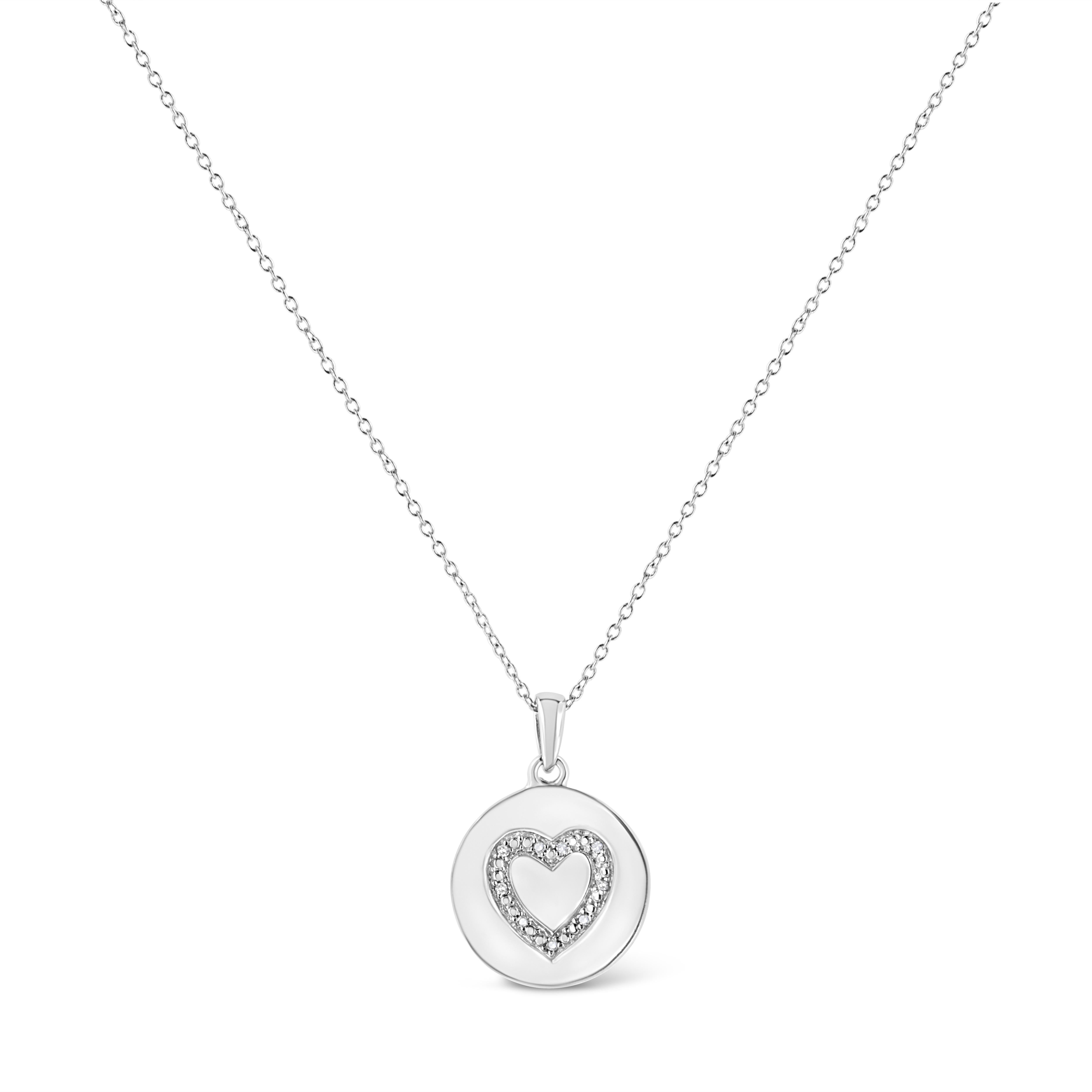 Tie an adorable heart on her neck. The heart shape of the pendant is stamped inside of a brushed sterling silver circle and is perfectly accented with a sprinkling of sparkling 9 share prong set single cut diamonds. The pendant hangs from a