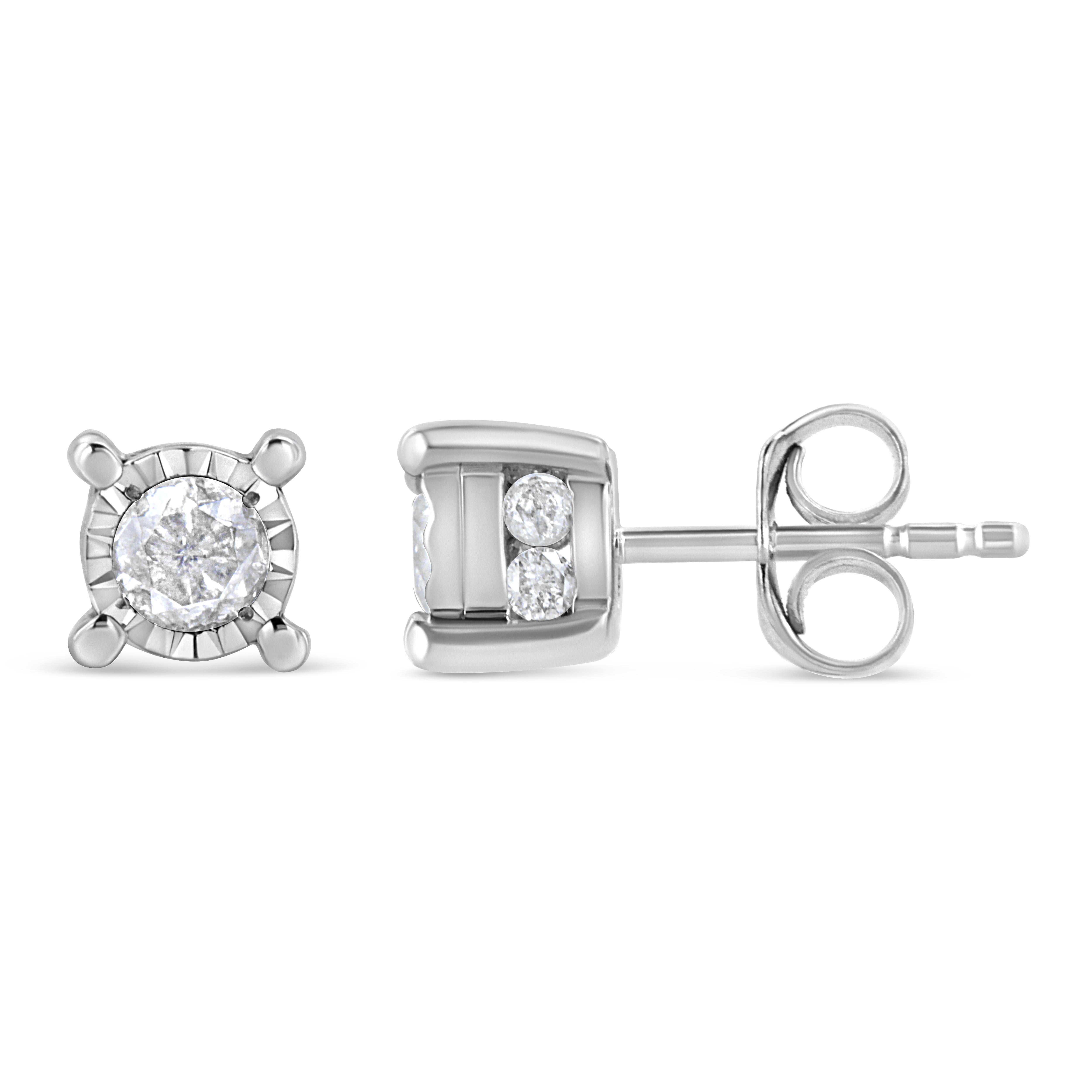 Ajoutez une touche chatoyante à votre garde-robe avec ces élégants et extravagants clous d'oreilles en diamant. Les boucles d'oreilles présentent 2 diamants ronds sertis dans une plaque miracle pour créer un aspect de diamant plus important. Dans le
