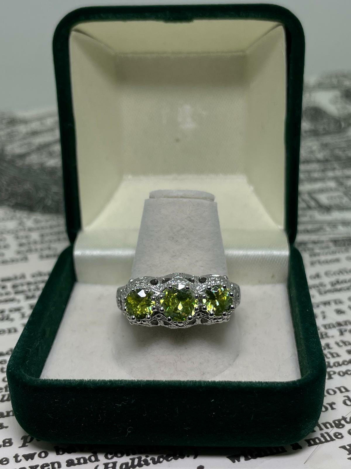 Meticulously Crafted in 925 Sterling Silver, 
centering 3 Green coloured Sparkling Crystals
with lovely flashes of red & orange,

set within gorgeous pierced gallery setting, 
featuring openwork & floral motifs 

Dimensions of the setting: 8mm (high
