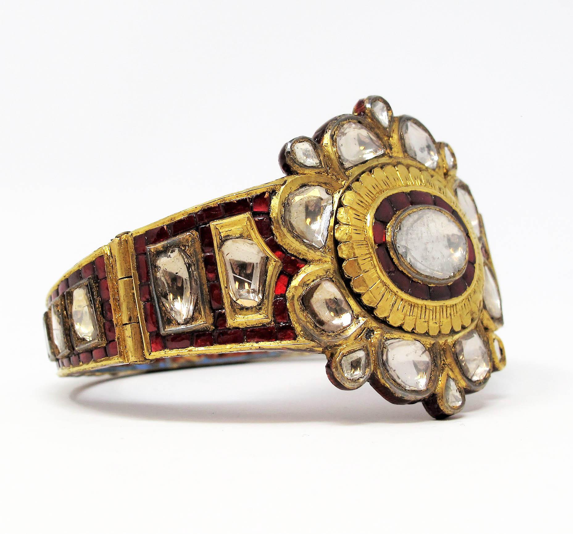 Incredible vintage Polki diamond bangle bracelet is an absolute work of art for your wrist! This stunning piece features an 18 karat gold and enamel bodice embellished with rounded rough cut diamonds throughout. The bold color and stunning,