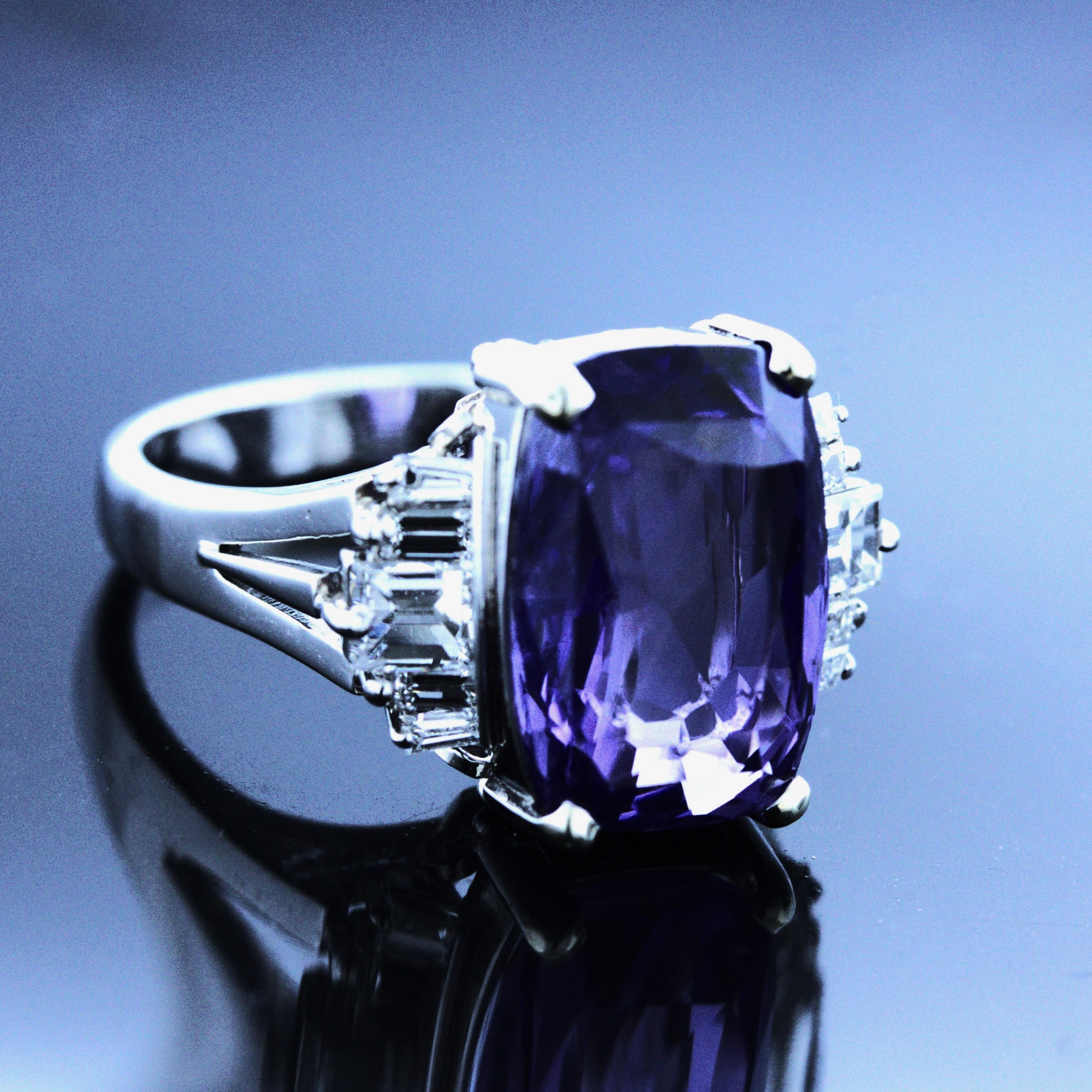 A beautiful, natural, and untreated color-change sapphire takes center stage. It weighs an impressive 9.27 carats and has a clean purple color that changes to blue in different lighting! It is certified by the GIA as unheated and natural with color