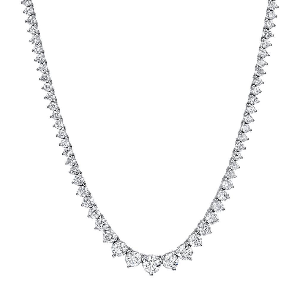 Exquisite diamond tennis chain in riviera style. Stunning diamonds are hand set in three prong mountings that are casted  in 14 karat white gold. Necklace features natural round brilliant cut diamonds weighing in 9.27 carats total ,F color, SI 1