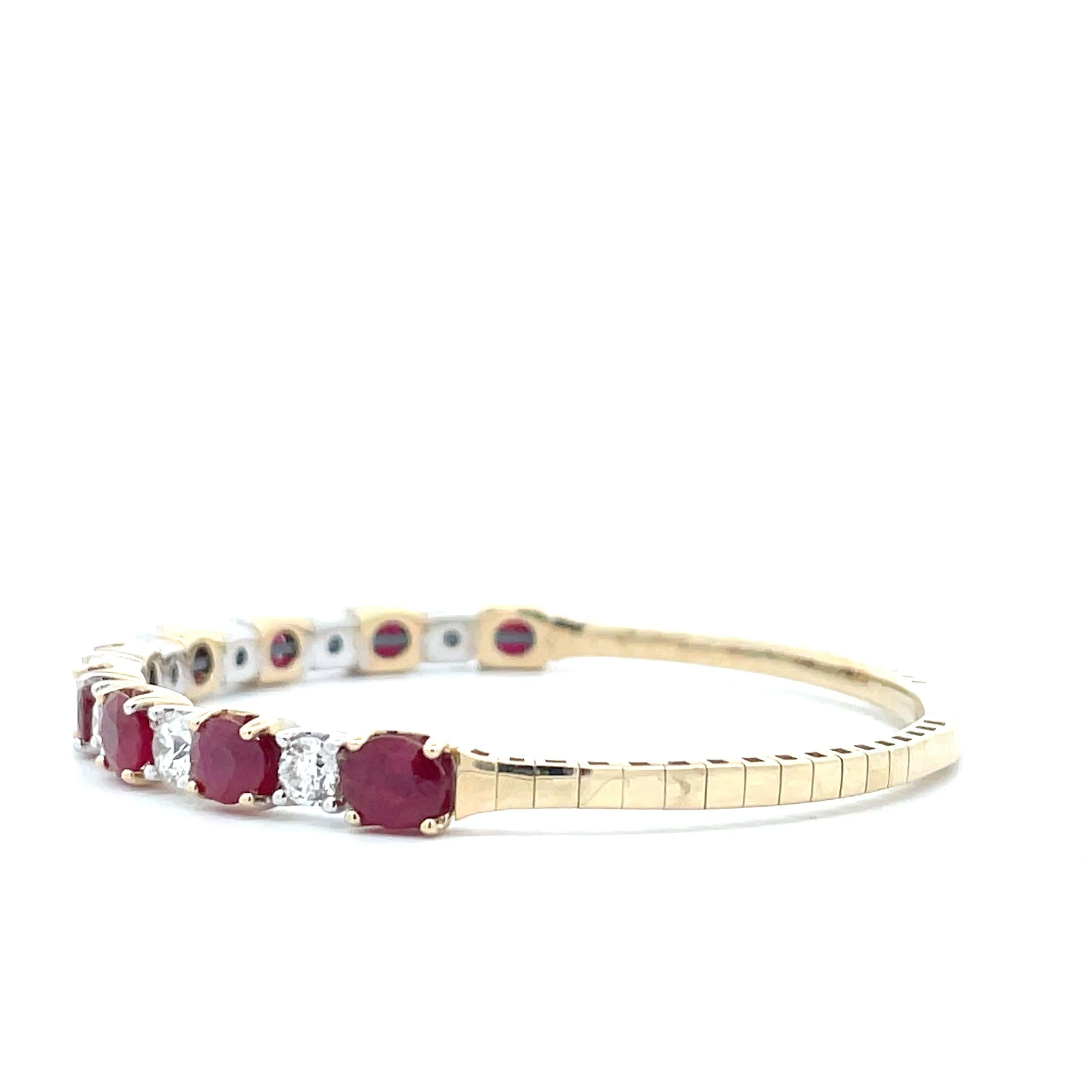 This 9.27ct. Alternating Oval Ruby & Diamond 14K Solid Gold Bangle is set with the most beautiful array of red rubies and white diamonds, alternating on the outside of the bangle. The stones on this piece are all eye clean, bright and sparkly; they