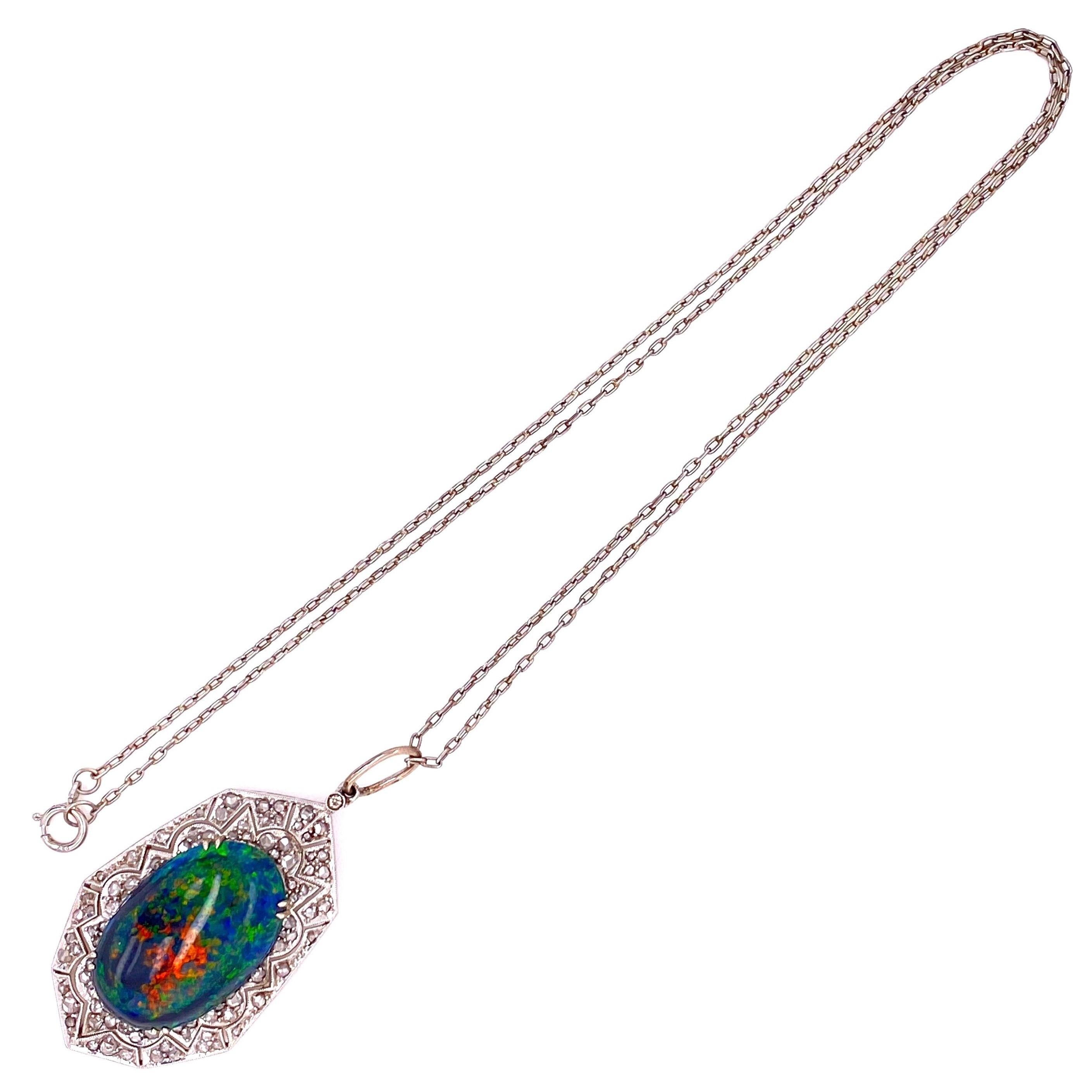 Simply Beautiful! Elegant and finely detailed Platinum Pendant Necklace set with a securely nestled 9.28 Carat Black Opal and surrounded by Brilliant-cut Diamonds, weighing approx. 0.90 total Carat weight. Hand crafted in Platinum, the Pendant