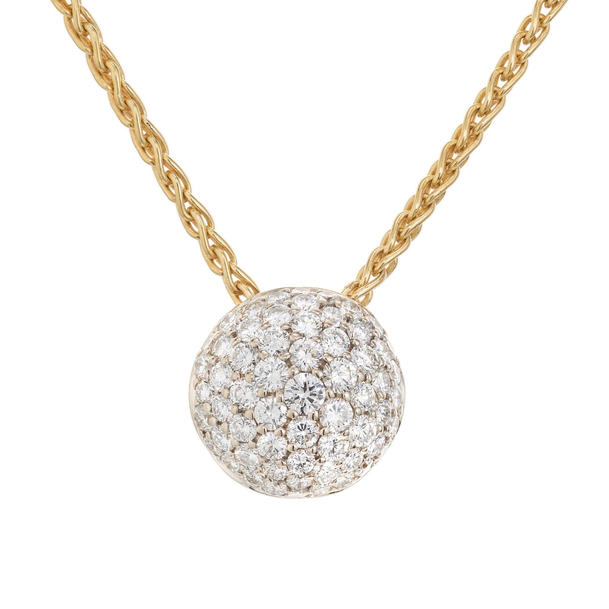 Diamond pendant necklace. 61 pave set round brilliant cut diamonds in a 14k white gold domed cluster formation. The back of the pendant is 18k yellow gold 16 inch  link chain.  

61 round brilliant cut diamonds, HI VS SI approx. .93cts
18k yellow