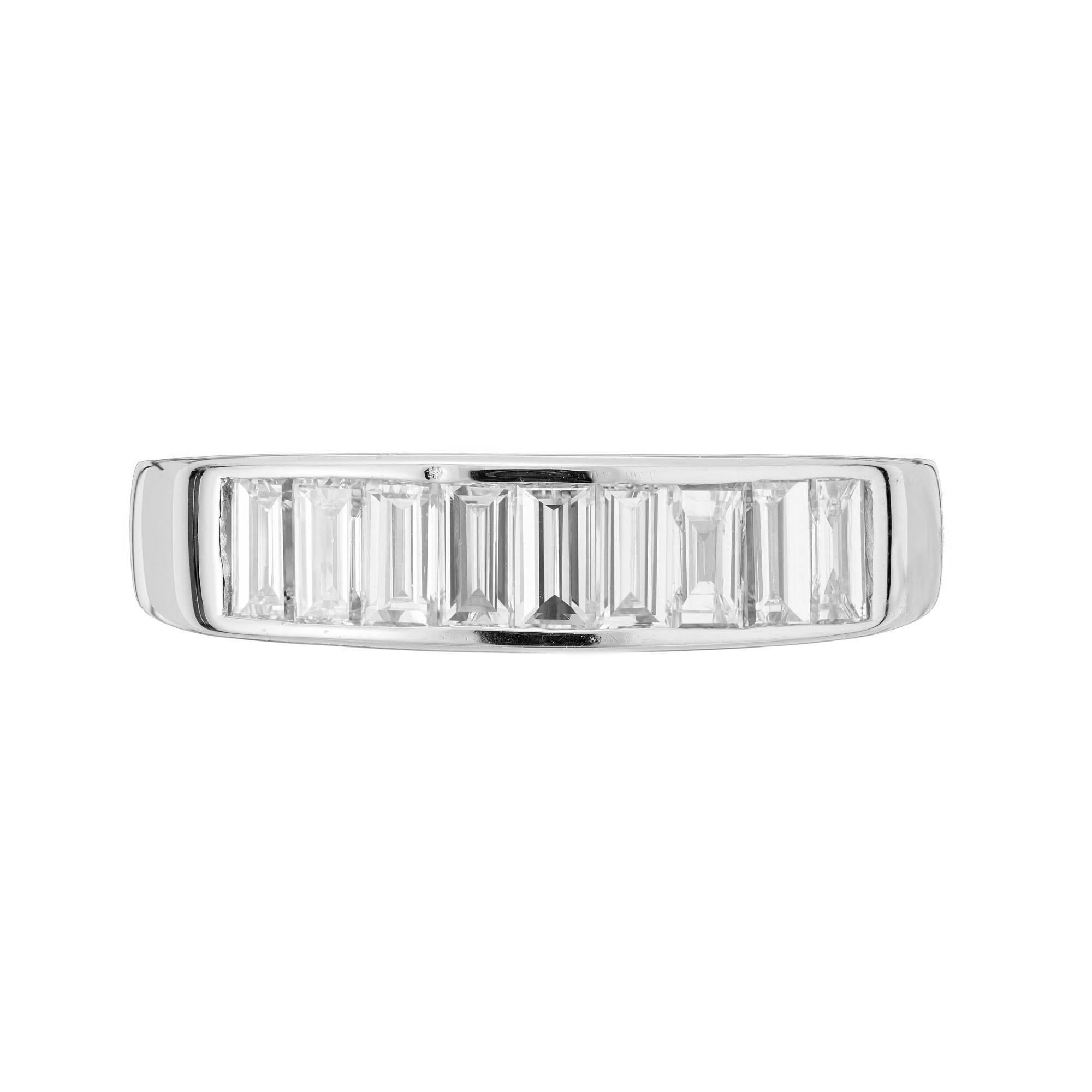 Diamond wedding band ring. 9 emerald cut Channel diamonds in a 18k white gold setting. Slightly raised top. 

9 Emerald cut diamonds, approx. total weight .93cts, H, VS1 – VS2 
Size 7.5 and sizable 
18k white gold
Tested: 18k
 Stamped: 750