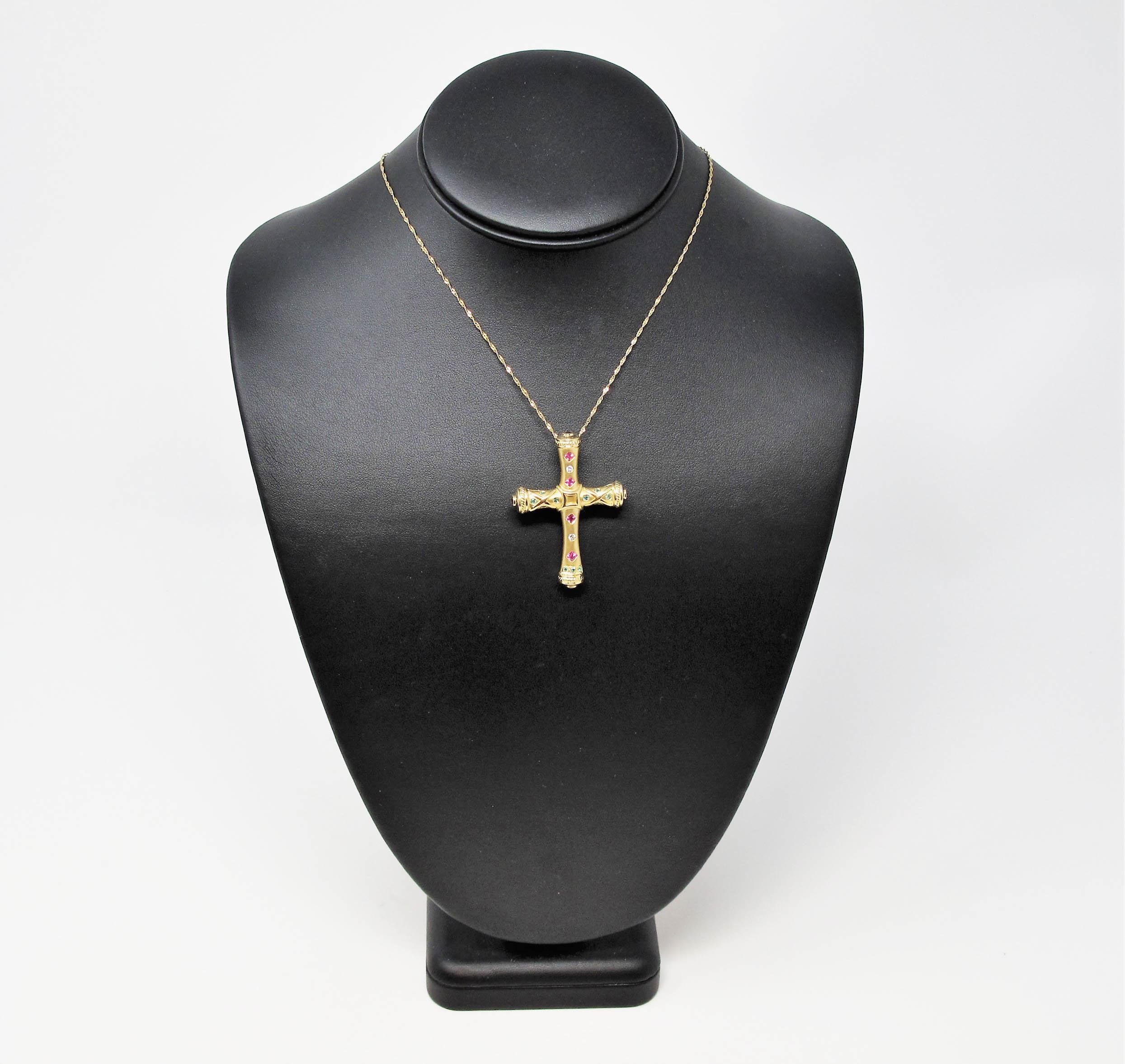 This incredible Etruscan style cross pendant / brooch is an absolute work of art. The smooth matte gold finish, paired with the vivid gemstones and glittering diamonds makes this versatile piece a stunning addition to your collection. 

This