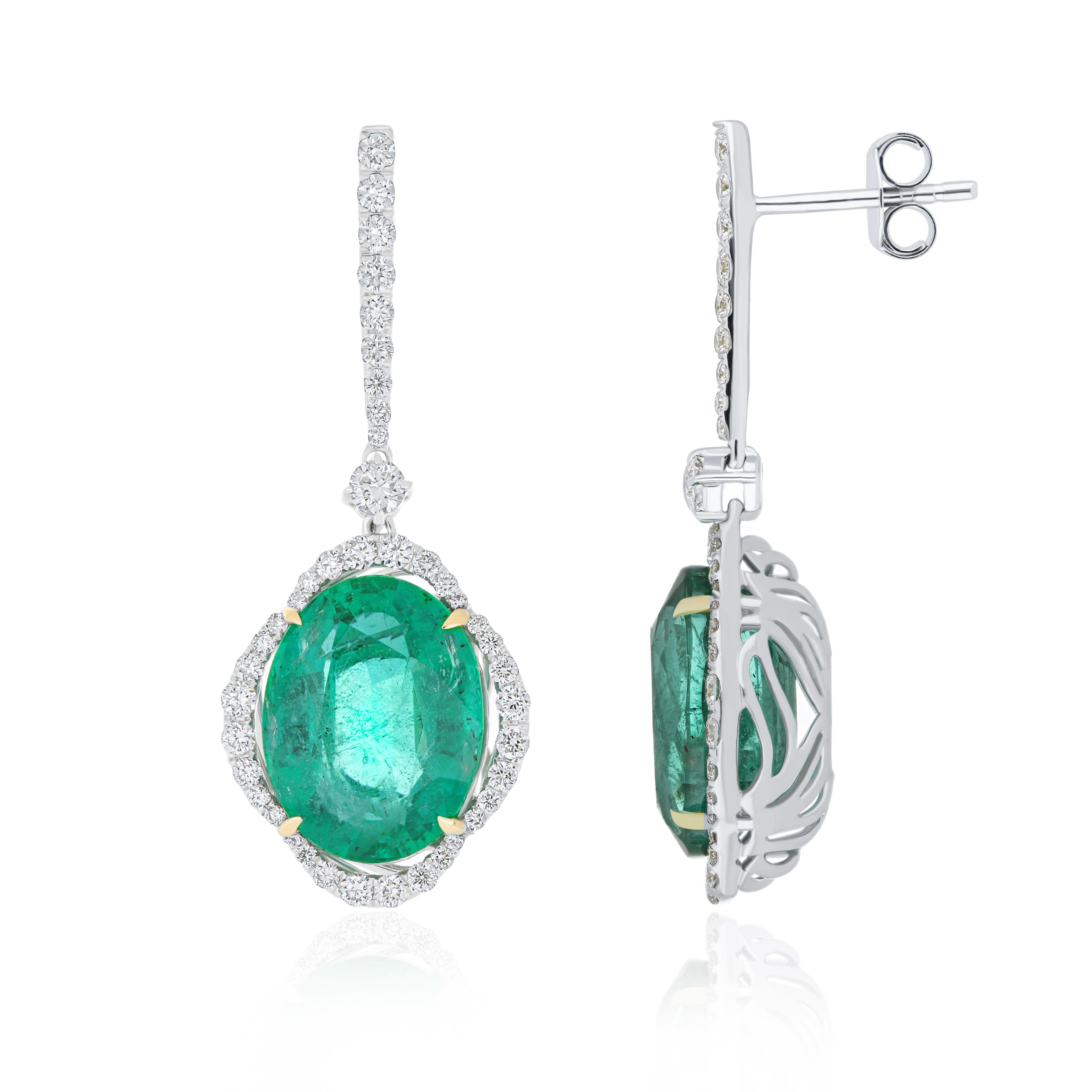 Elegant and Exquisitely detailed White Gold earrings, with 9.3 Cts. (total approx.) Emerald cut in Unique Oval Shape accented with micro pave Diamonds, weighing approx. 0.9cts. (total approx.). total carat weight. Beautifully Hand-Crafted Earring in