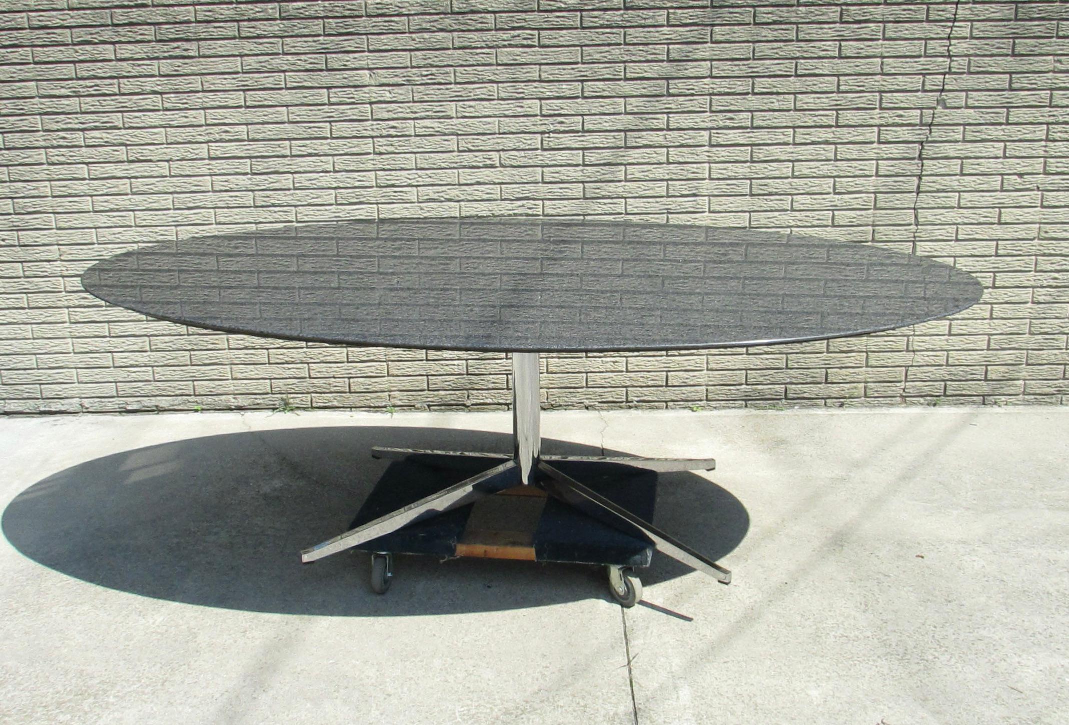 Almost eight foot by four and a half foot black andes graniter top on polished chrome base .  Beautifully simple design allows the large table to fit in anywhere . Dining table at home . Desk or conference table in the office . Solid steel chrome