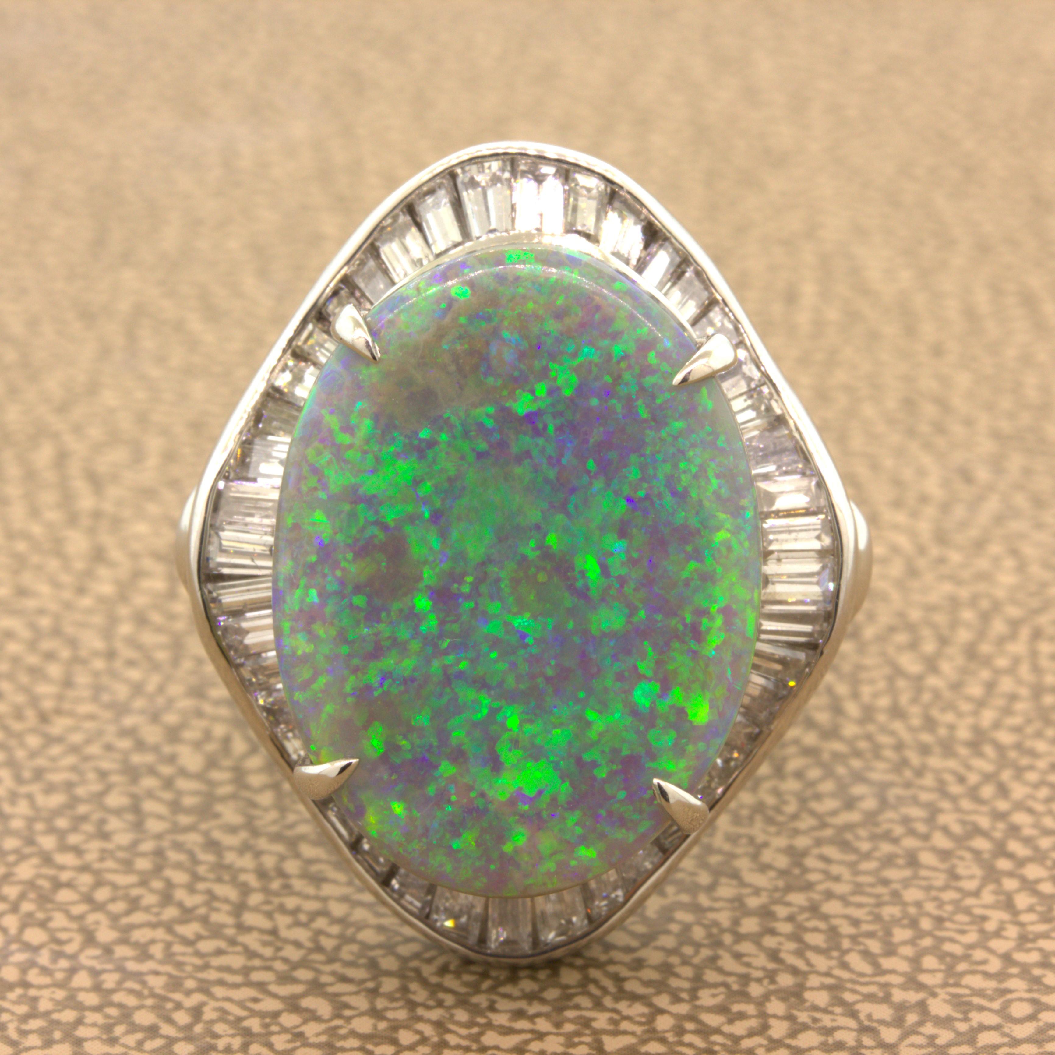A beautiful gem Australian opal takes center stage of this well-made platinum ring. It weighs an impressive 9.30 carats and has excellent play-of-color. The opal has a very strong pin-fire pattern which shimmers in the light with colors of primarily