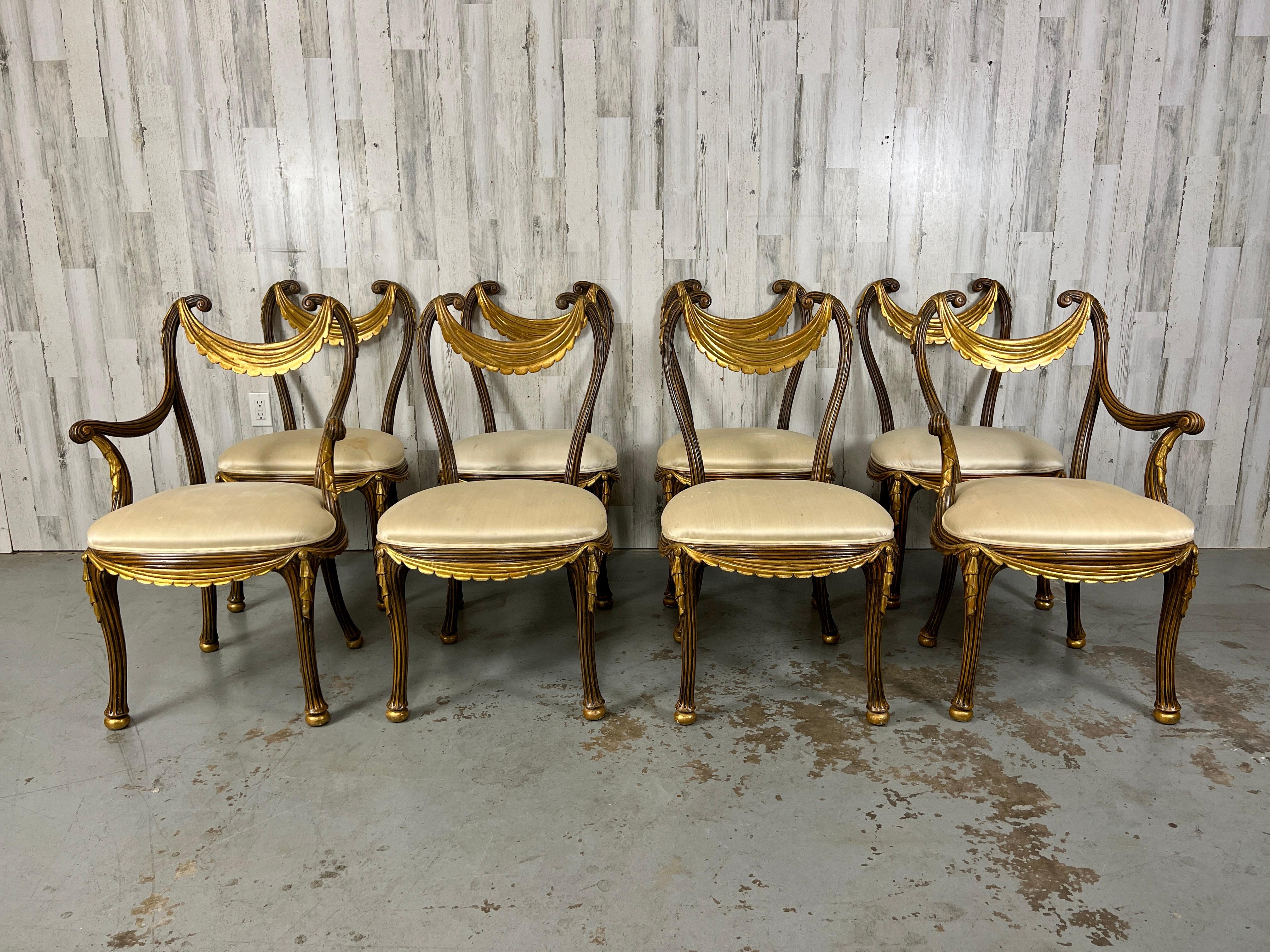 Very rare set of eight, two arm and six side gilt wood Dining chairs. A combination of wood, gesso, gilt and upholstery make these chairs stunning from all angles. Very sturdy and in very good vintage condition. Arm Chairs are 23.5